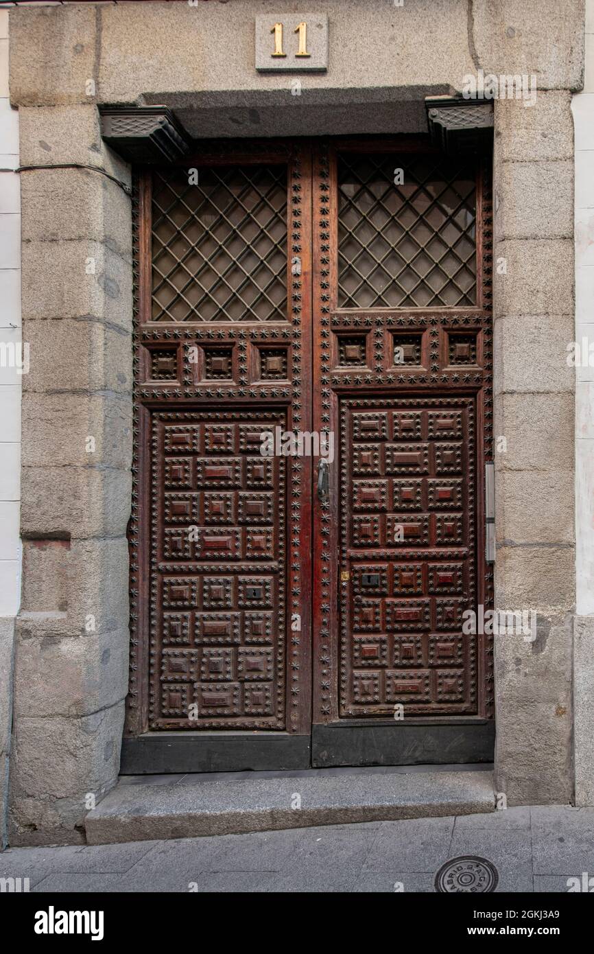 Antigua puerta con paneles de madera con remaches metálicos a la entrada de  un edificio antiguo en el centro de Madrid Fotografía de stock - Alamy