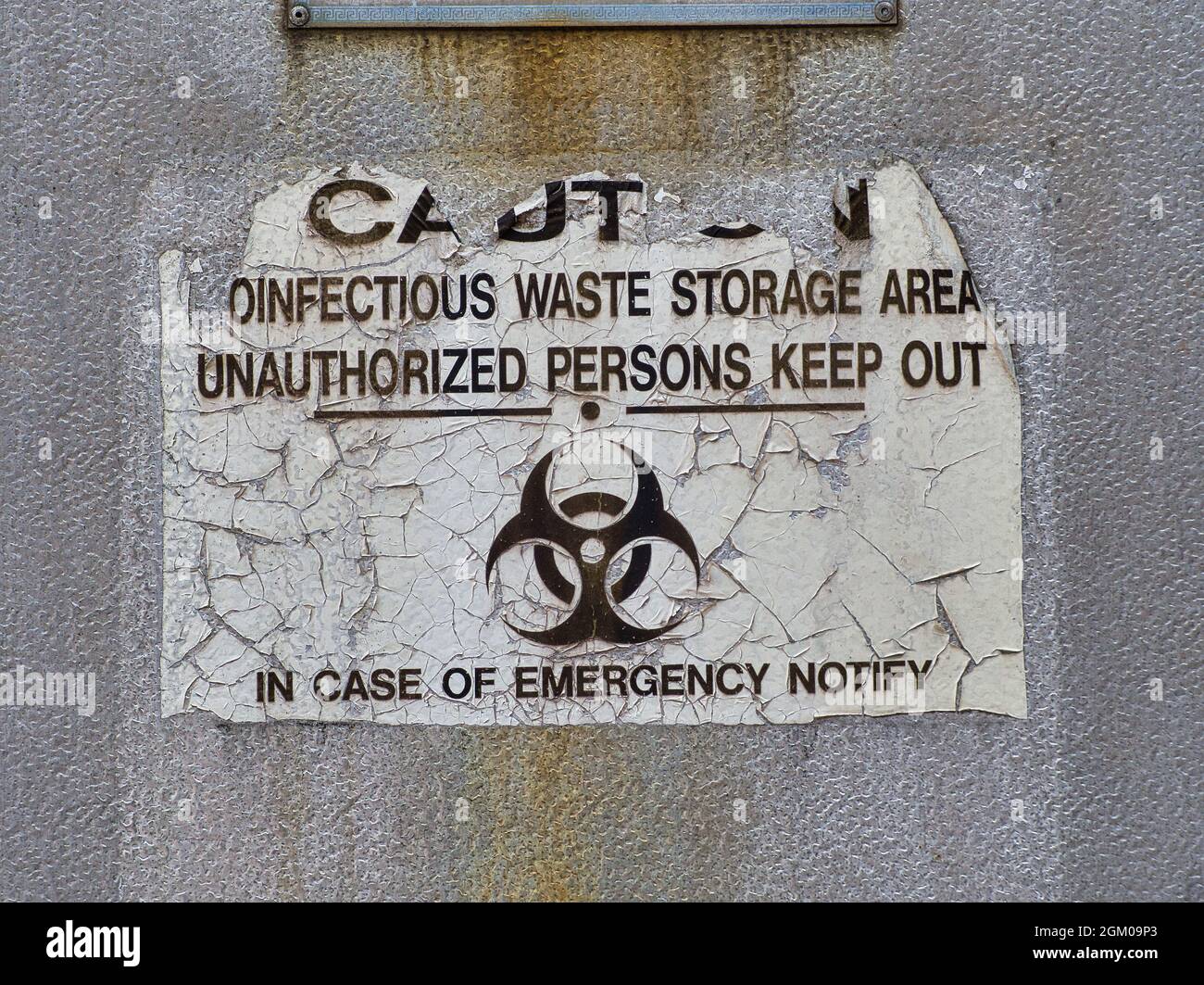 etiqueta de advertencia en un armario de almacenamiento de residuos de enfermedades infecciosas Foto de stock