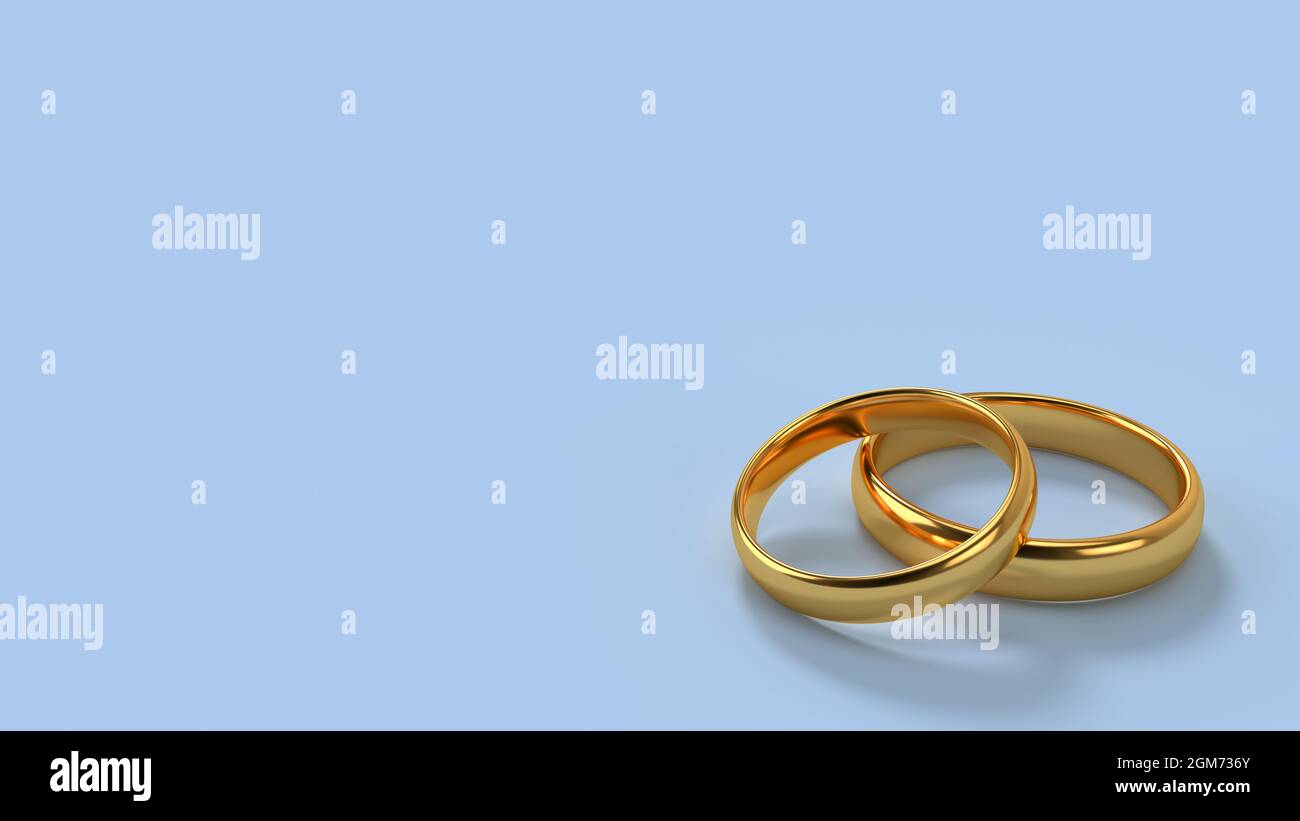 Dos anillos de oro de boda se encuentran uno sobre otro con espacio en blanco de fondo para texto. Formato 16x9. 3d renderizado Foto de stock