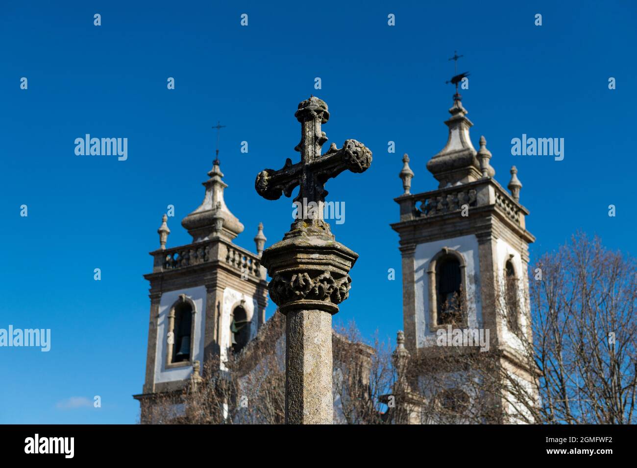 Detalle de una antigua cruz de piedra en frente de una iglesia, en la ciudad de Guarda, Portugal Foto de stock