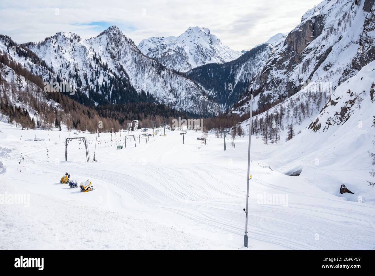 Desiertas pistas de esquí rodeadas de majestuosos picos nevados en los Alpes en invierno Foto de stock