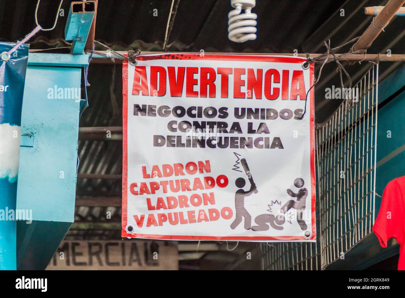 ANTIGUA, GUATEMALA - 27 DE MARZO de 2016: Señal de advertencia en el mercado de Antigua Guatemala. Dice: Advertencia. Empresas unidas contra la delincuencia. C Foto de stock