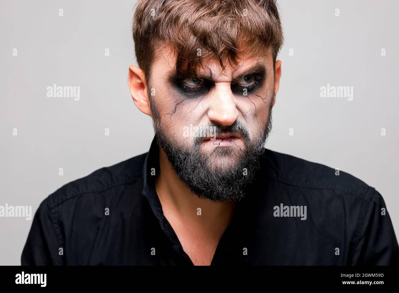 Retrato de un hombre con barba y un look amenazador con maquillaje al  estilo de los muertos vivientes el día de Todos los Santos el 31 de octubre  Fotografía de stock - Alamy