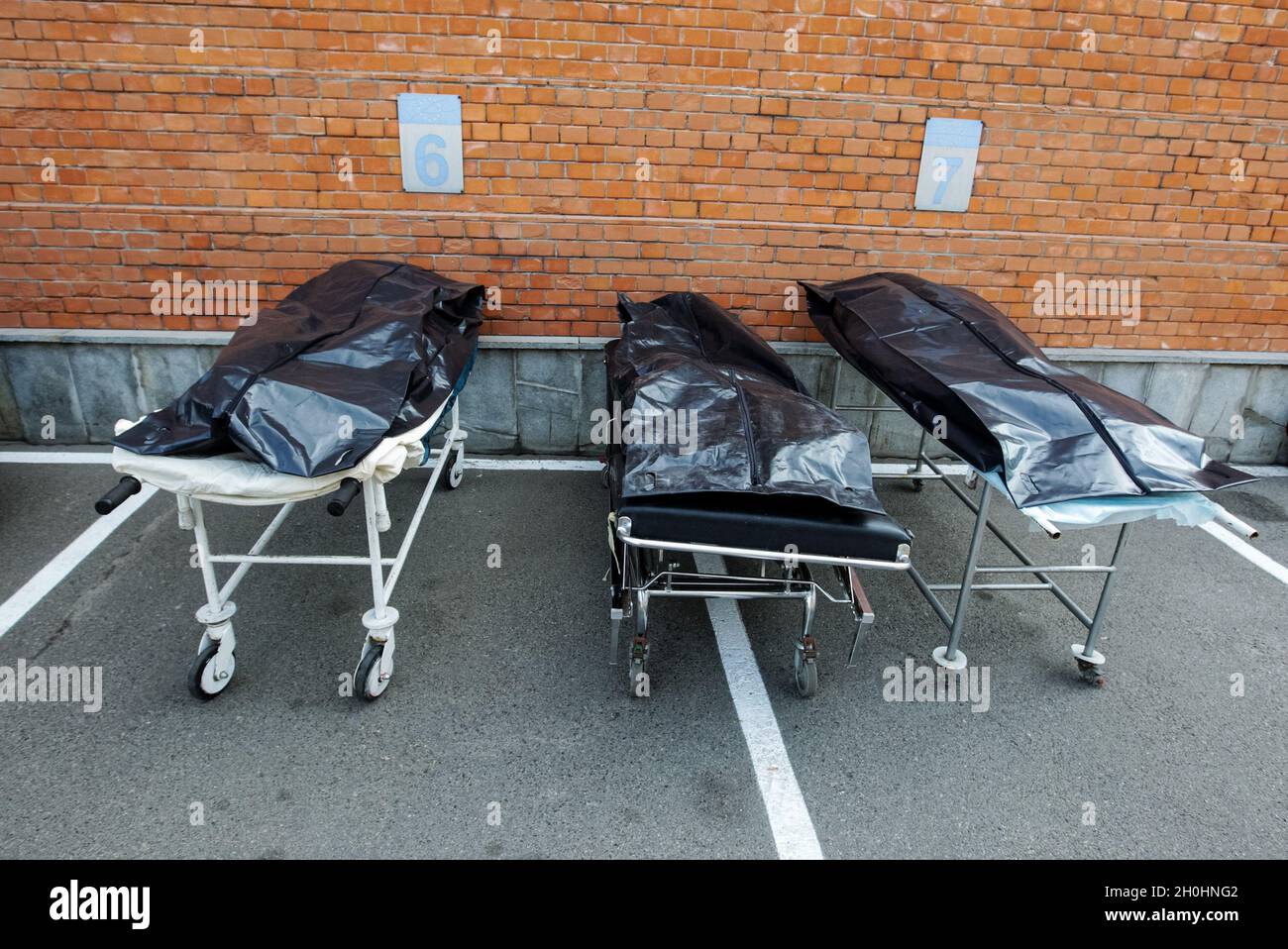 NOTA DEL EDITOR: La imagen representa la muerte)Las camillas médicas con  bolsas negras que representan cuerpos durante un rally que exigen  exenciones de patentes para las vacunas COVID-19, fuera de la Oficina