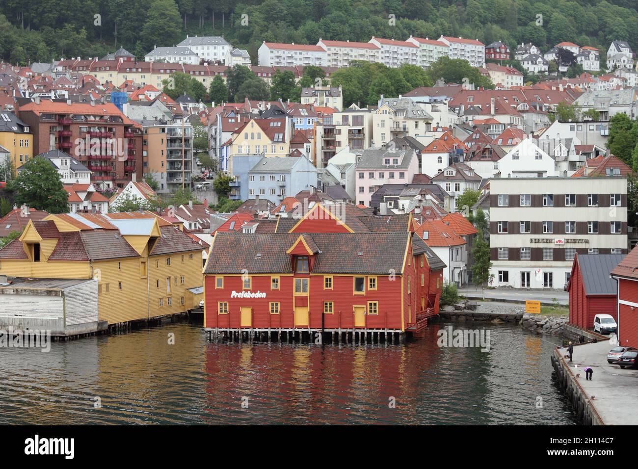 Bergen, Noruega - 13 de junio de 2021: Edificio de almacenes en el puerto y la ciudad Foto de stock