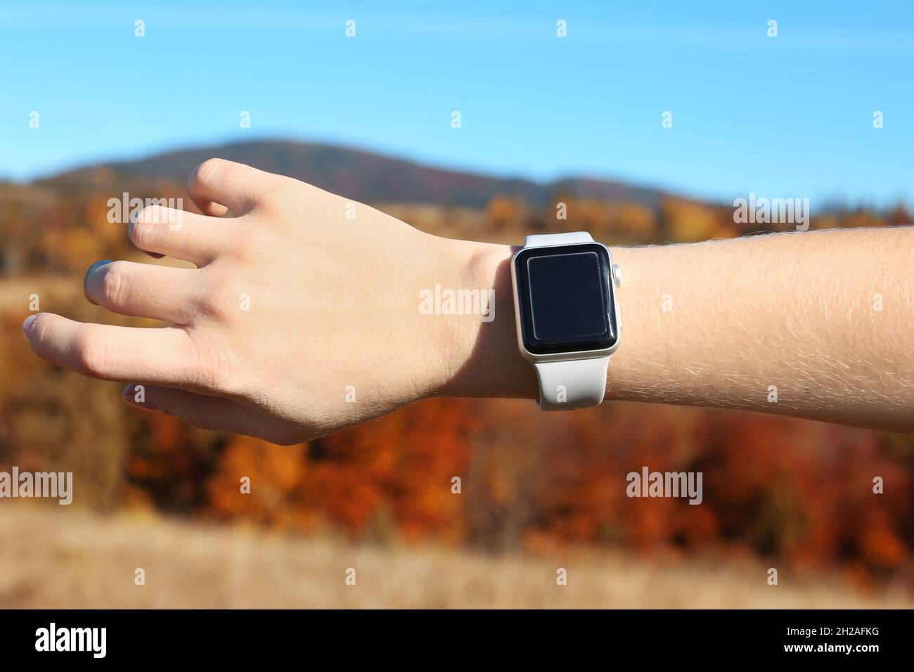 Mujer comprobando reloj inteligente con pantalla en blanco en el desierto,  primer plano Fotografía de stock - Alamy
