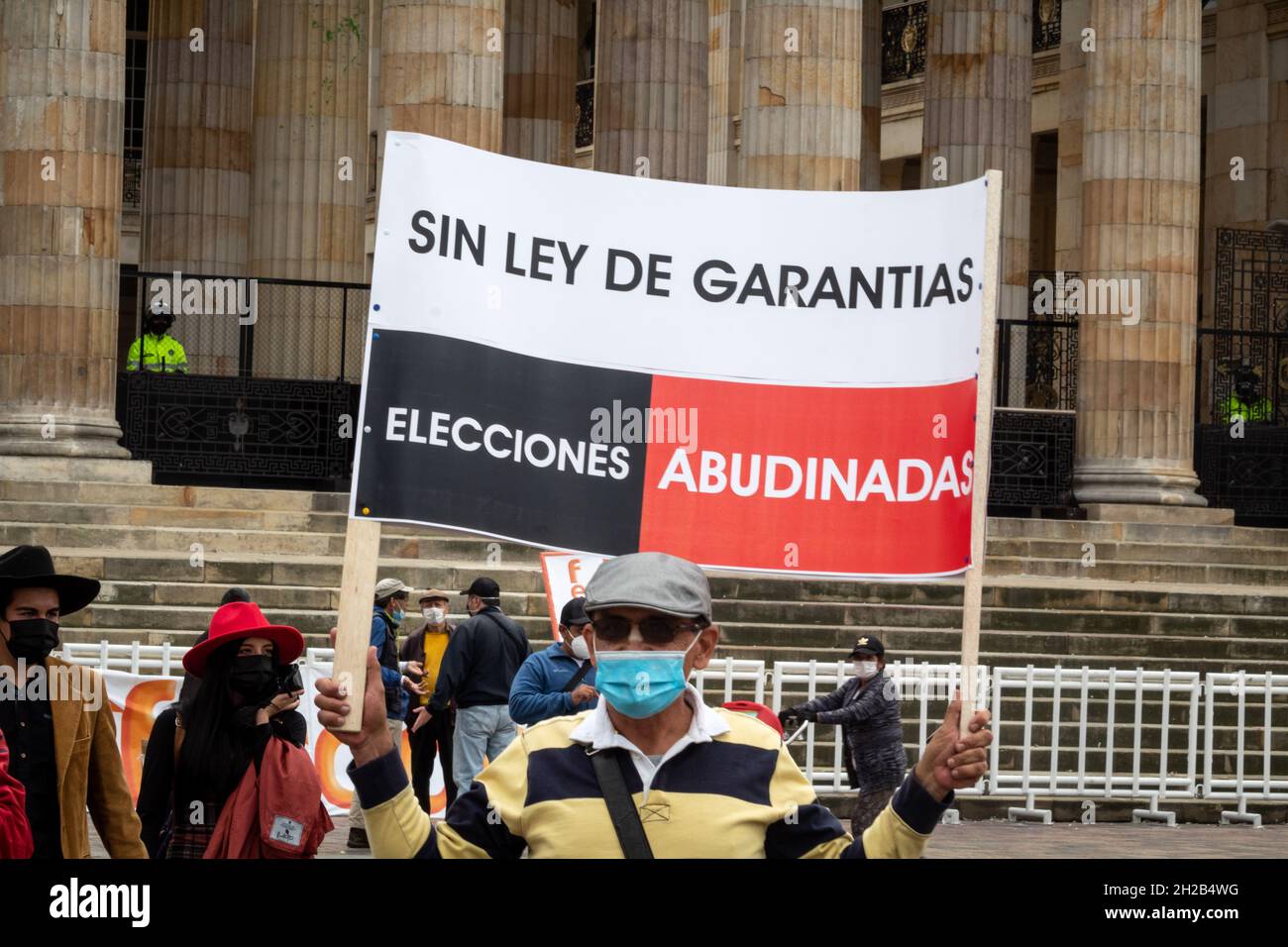 Bogotá, Colombia, 20 de octubre de 2021. Un manifestante tiene una señal que dice 'No hay ley de subsidios, elecciones robadas' durante una protesta contra las leyes y leyes del gobierno colombiano en el Congreso. En Bogotá, Colombia, el 20 de octubre de 2021. Foto de stock