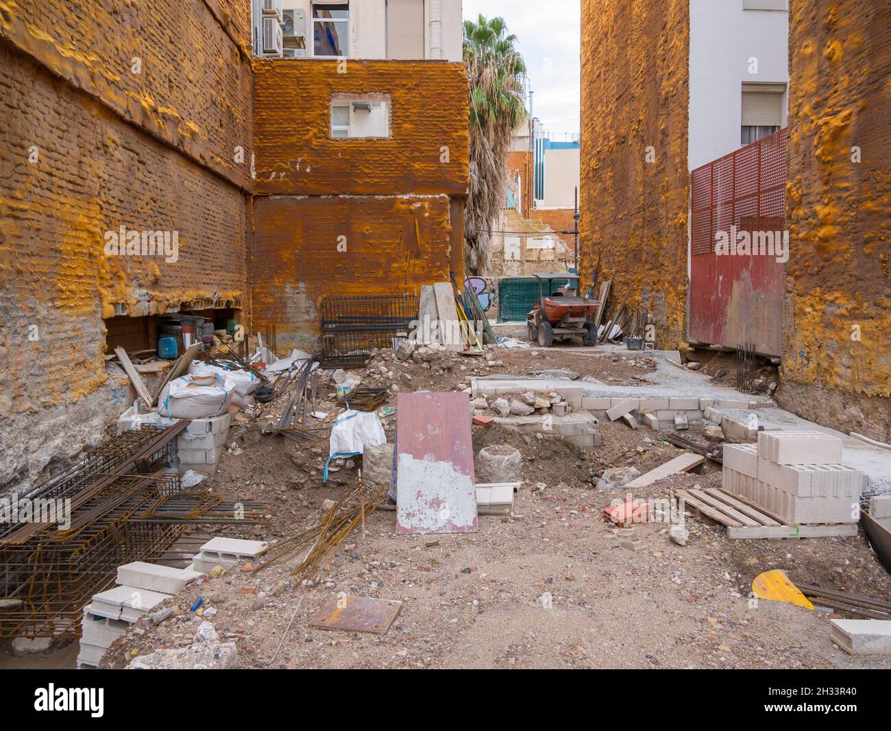 Un lugar de construcción donde las fundaciones están siendo colocadas entre dos bloques de apartamentos en la Ciudad de Cartagena, España. Foto de stock