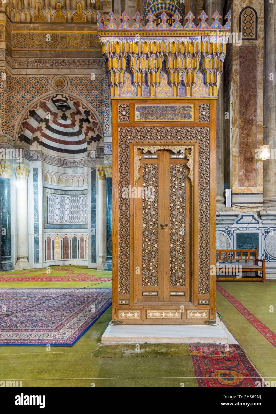 Antigua puerta Minbar de madera con decoraciones arabescas lengua y ranura ensamblada, incrustada con marfil y ébano, y Mihrab en la parte trasera, en la histórica mezquita pública de Rifaii, Mezquita Real, El Cairo, Egipto Foto de stock