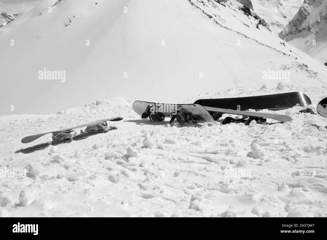 Tablas de snowboard en pendientes nevadas en altas montañas de invierno. Montañas del Cáucaso, región de Dombay. Paisaje en blanco y negro. Foto de stock