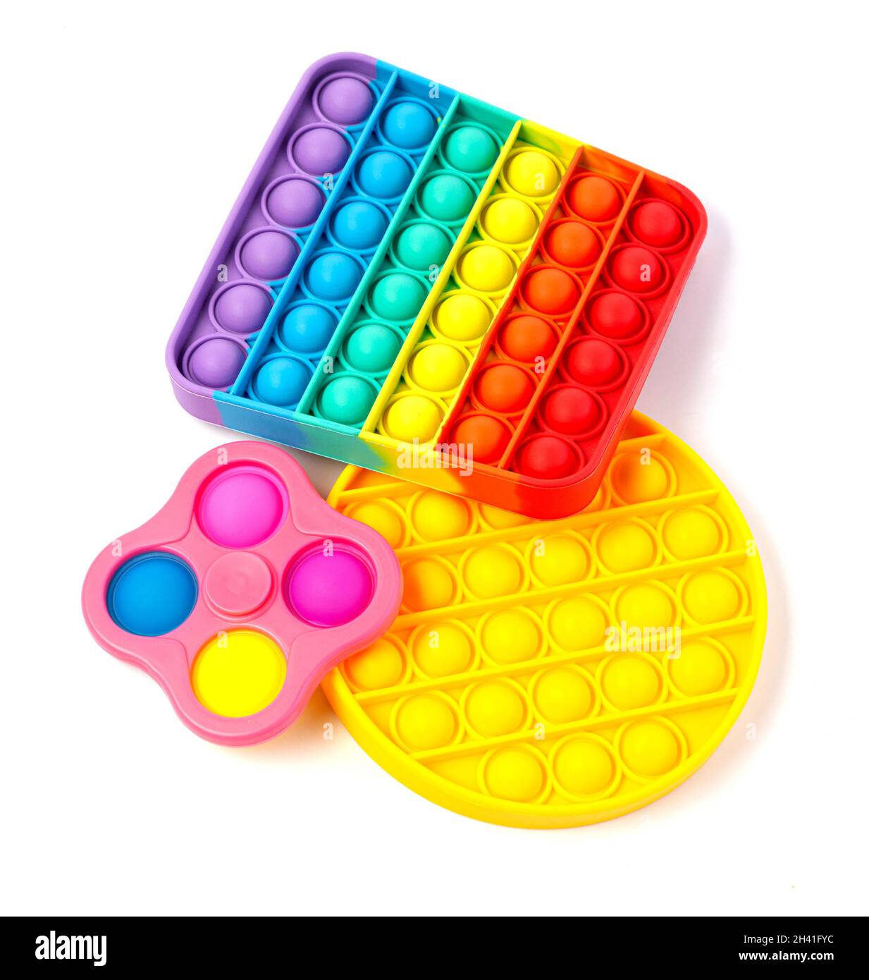 Pop It Simple Dimple - silicona sensorial anti-estrés Fidget juguete colorido arco iris juego aislado sobre fondo blanco, espacio de copia. Foto de stock