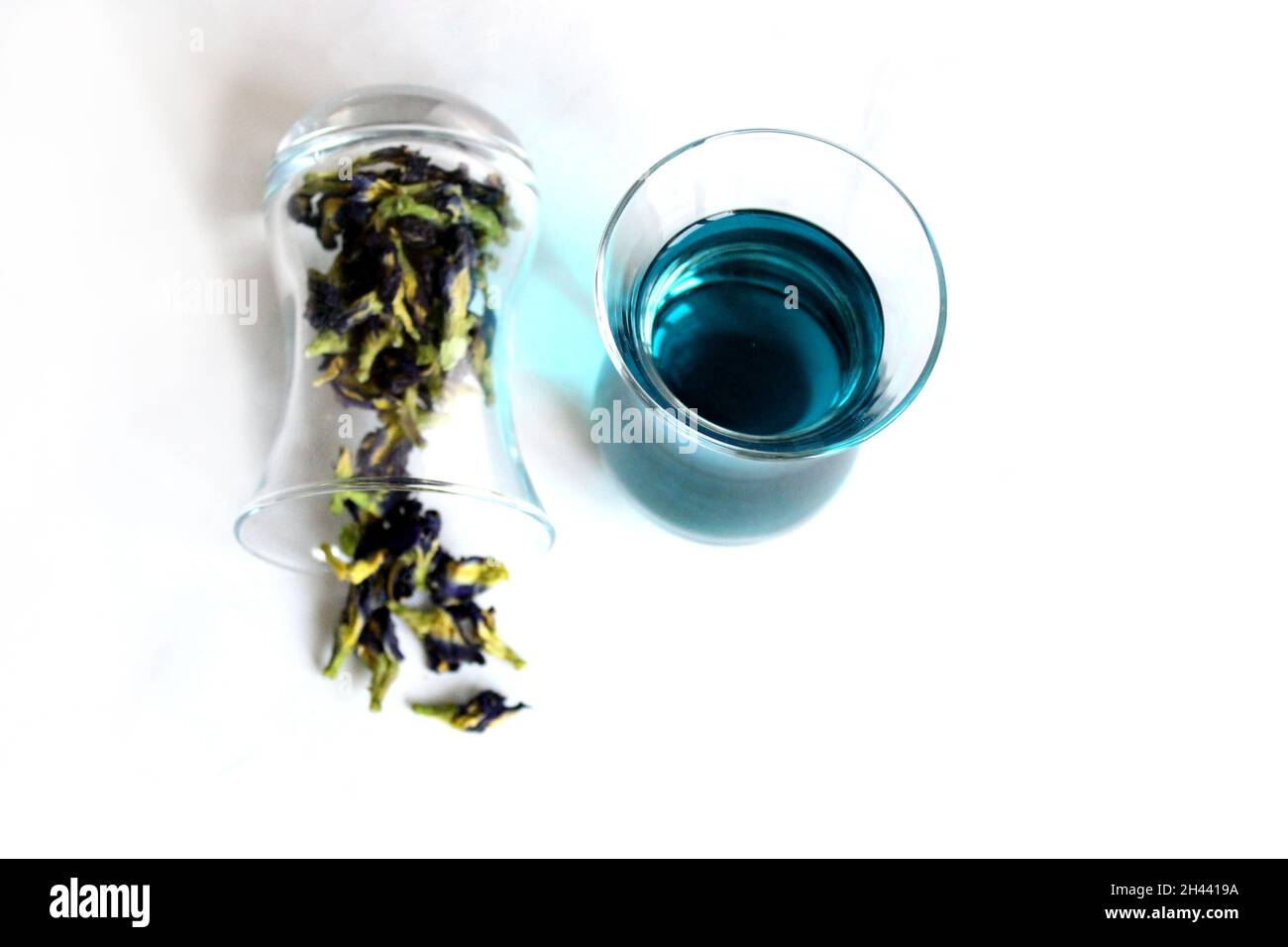Bebidas Saludables, orgánicos mariposa azul flor de guisante té con limas y limones, cemento gris espacio copia en segundo plano vista superior Foto de stock