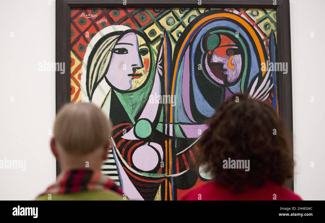 Dos mujeres mirando a la chica de Pablo Picasso antes de un espejo, 1932,  durante una vista previa de la exposición Picasso 1932 - Amor, fama,  tragedia en Tate Modern en Londres.