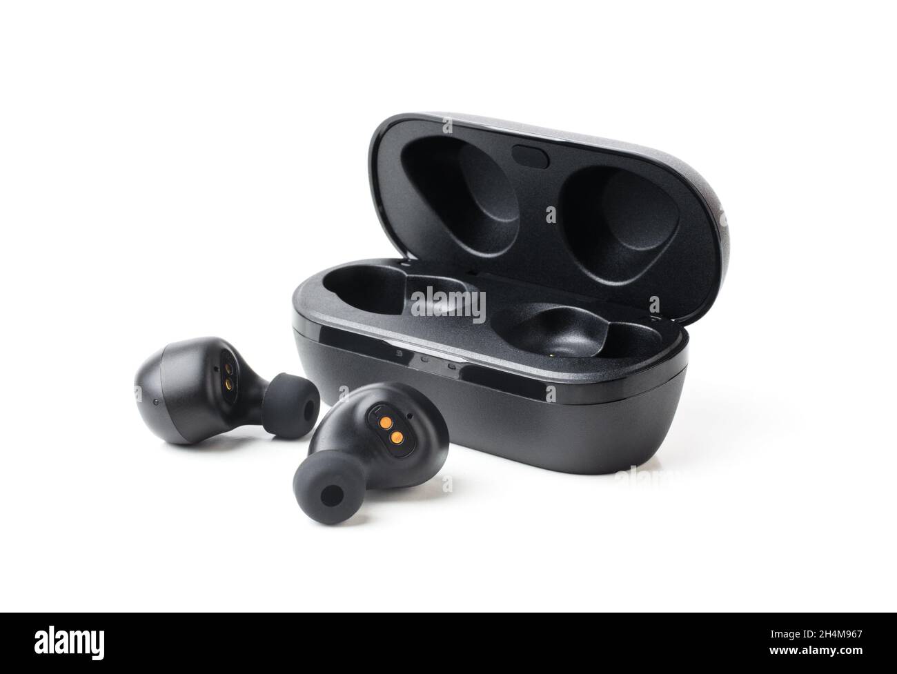 Los auriculares Bluetooth inalámbricos negros con carga sin contacto aíslan el primer plano sobre un fondo blanco Foto de stock