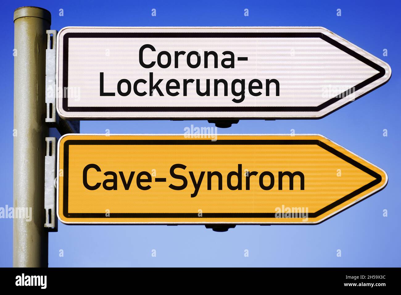 FOTOMONTAGE, Wegweiser Corona-Lockerungen und Cave-Syndrom Foto de stock