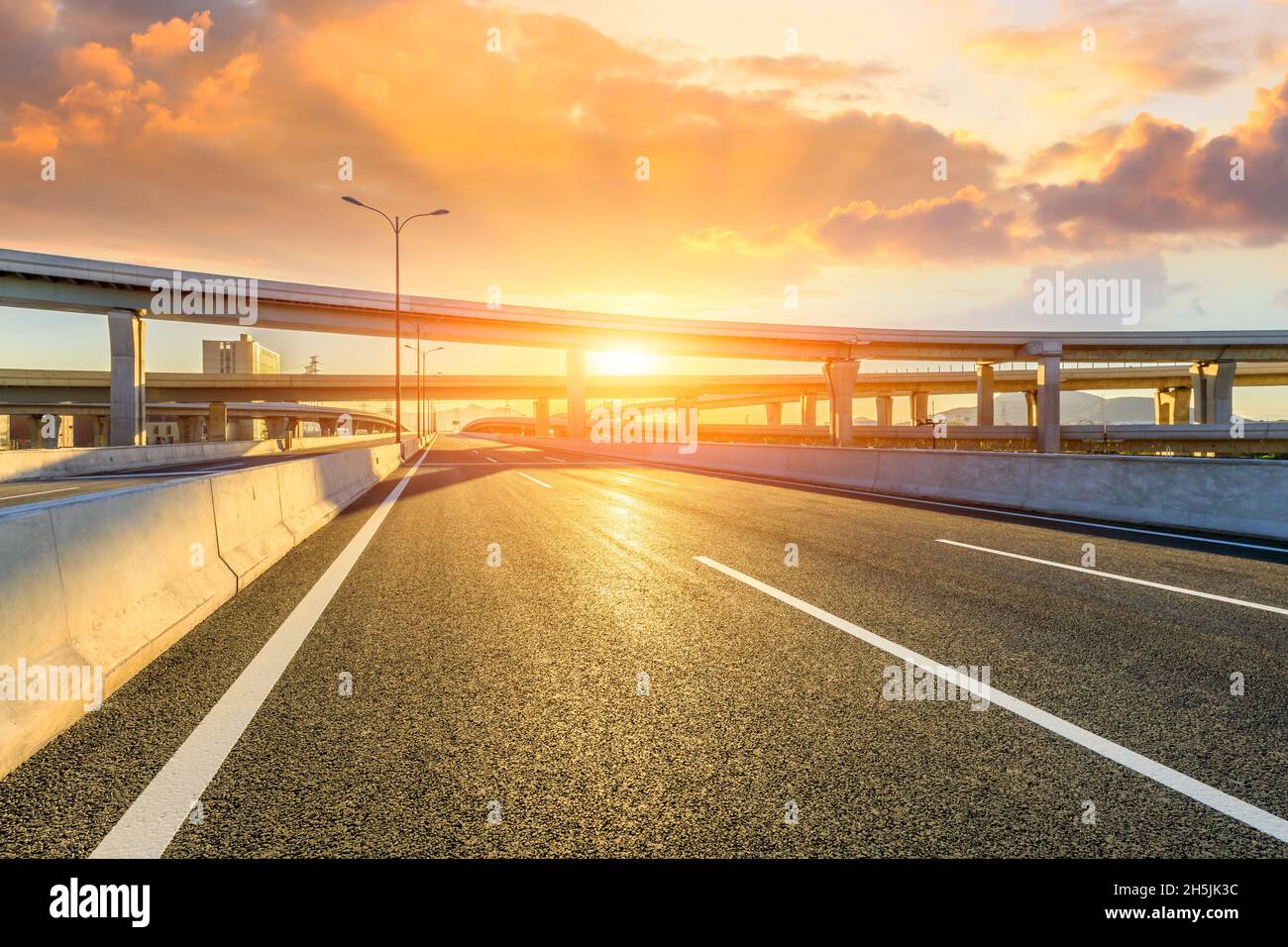Escenario de construcción de puentes y autopistas de asfalto al amanecer. Foto de stock