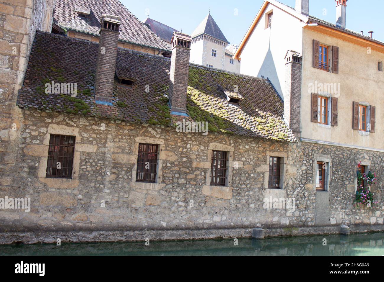 Antiguo edificio histórico de piedra con algas en el canal, Le Palais