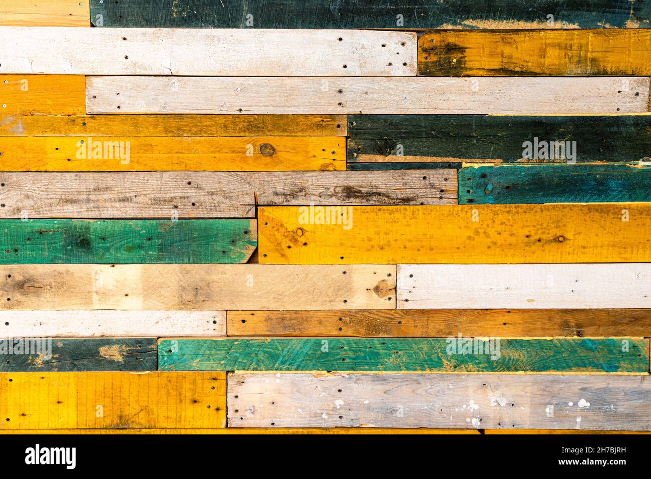 Las tablas de madera están clavadas en una pared blanca para una decoración,  fondo de textura de tablones de madera en colores pastel