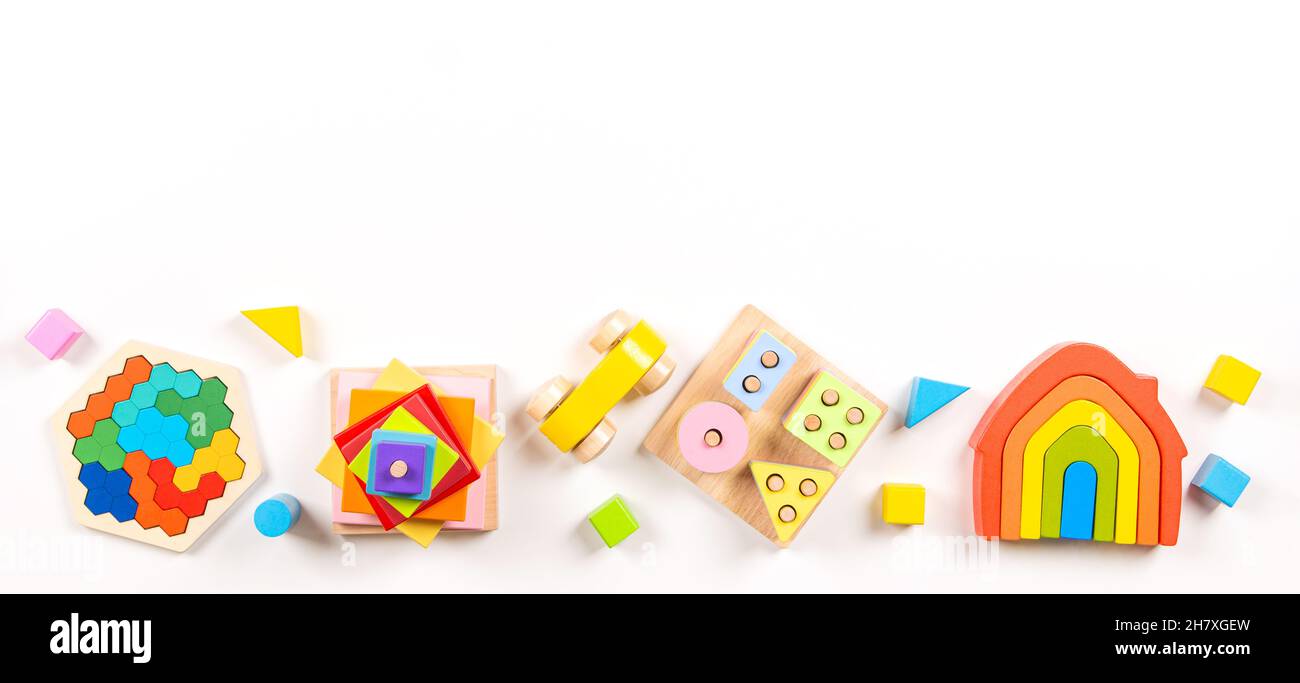 Bebé niños juguetes bandera fondo. Vista superior de coloridos juguetes educativos de madera sobre fondo blanco. Educación temprana, cero residuos, juguetes Montessori para Foto de stock