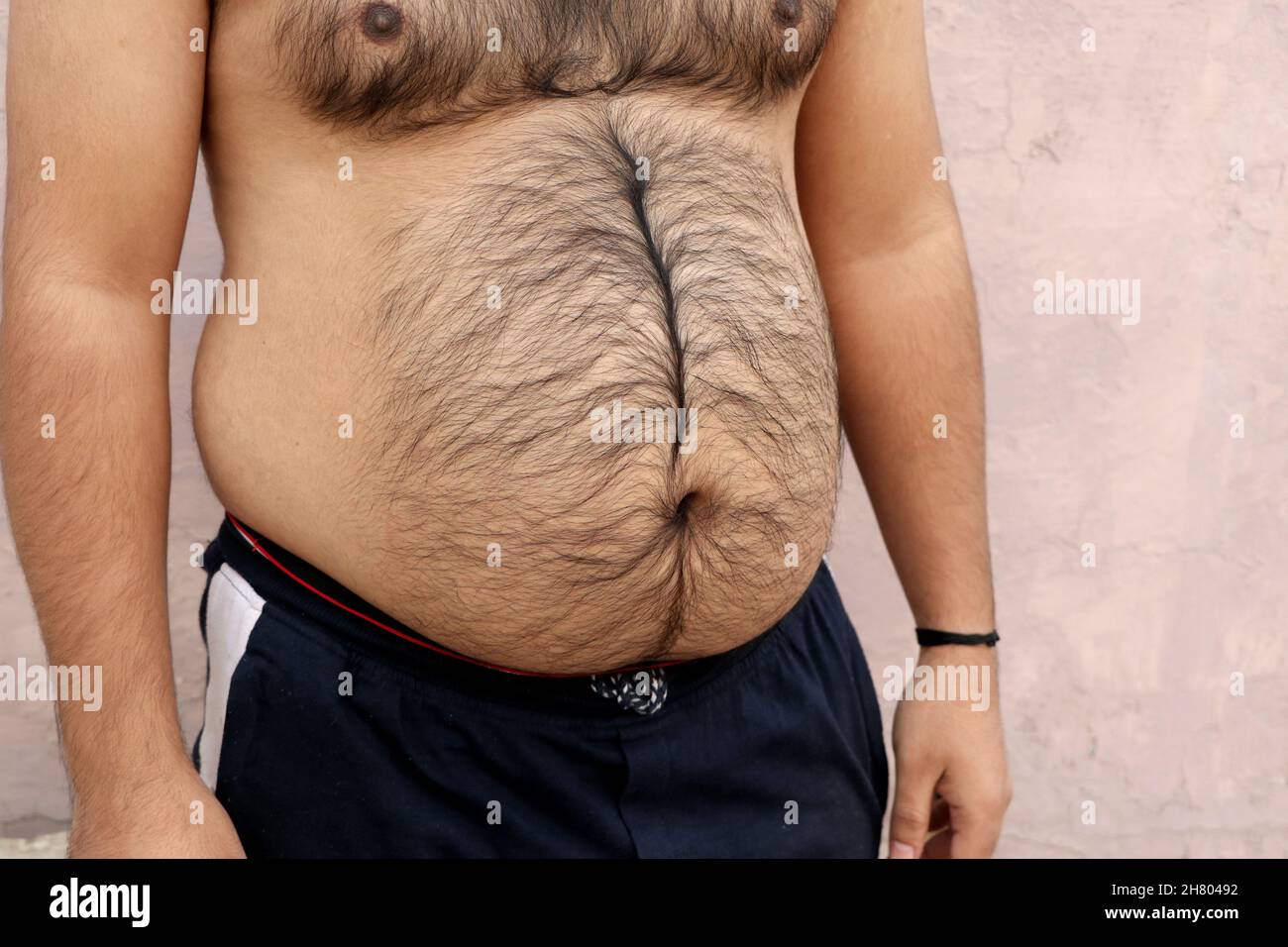 Un retrato de un hombre gordo asiático muestra su cuerpo y su gran vientre. Concepto de Obesidad Foto de stock