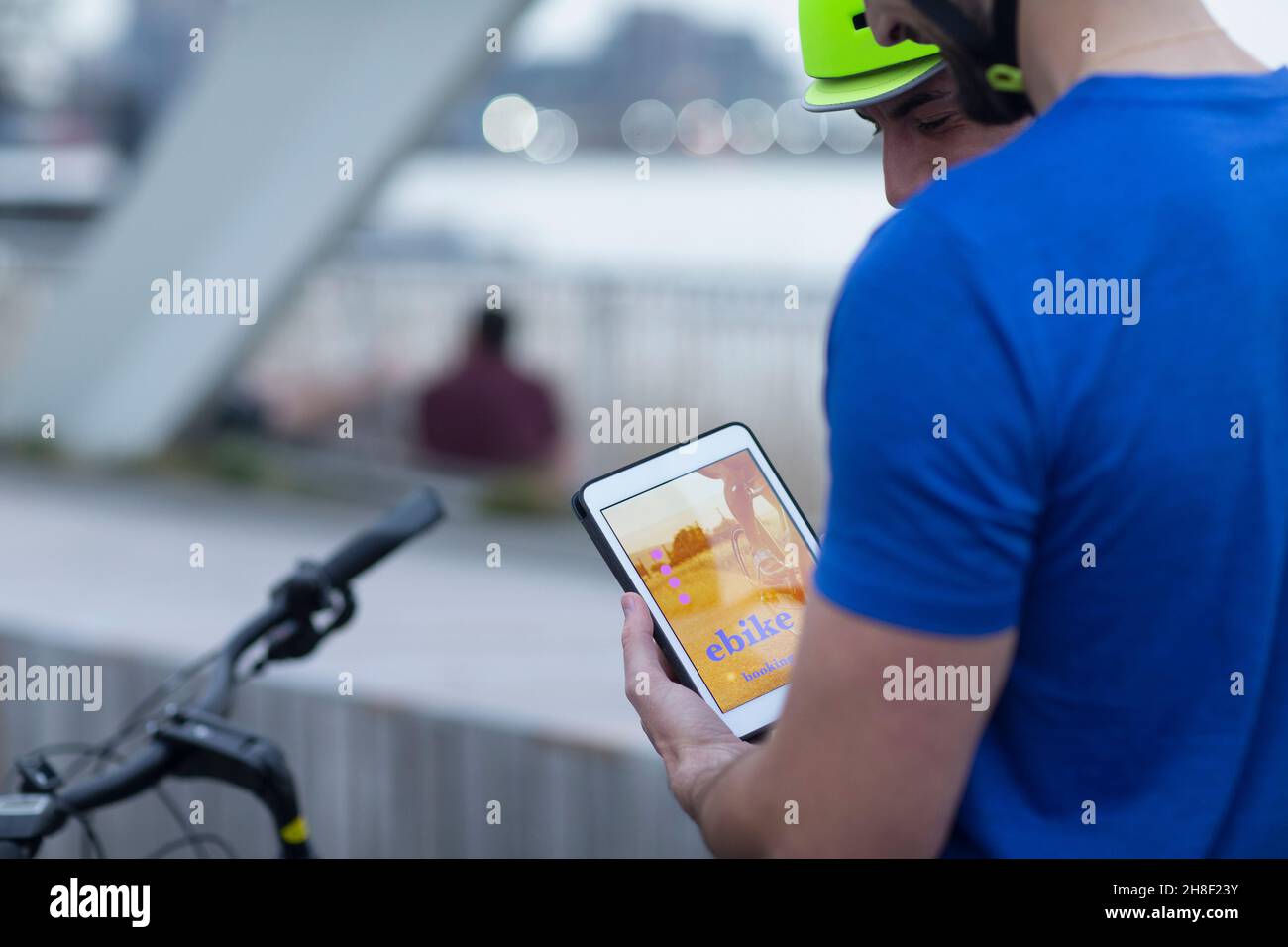 Hombre con tableta digital alquilar bicicleta con aplicación móvil Foto de stock