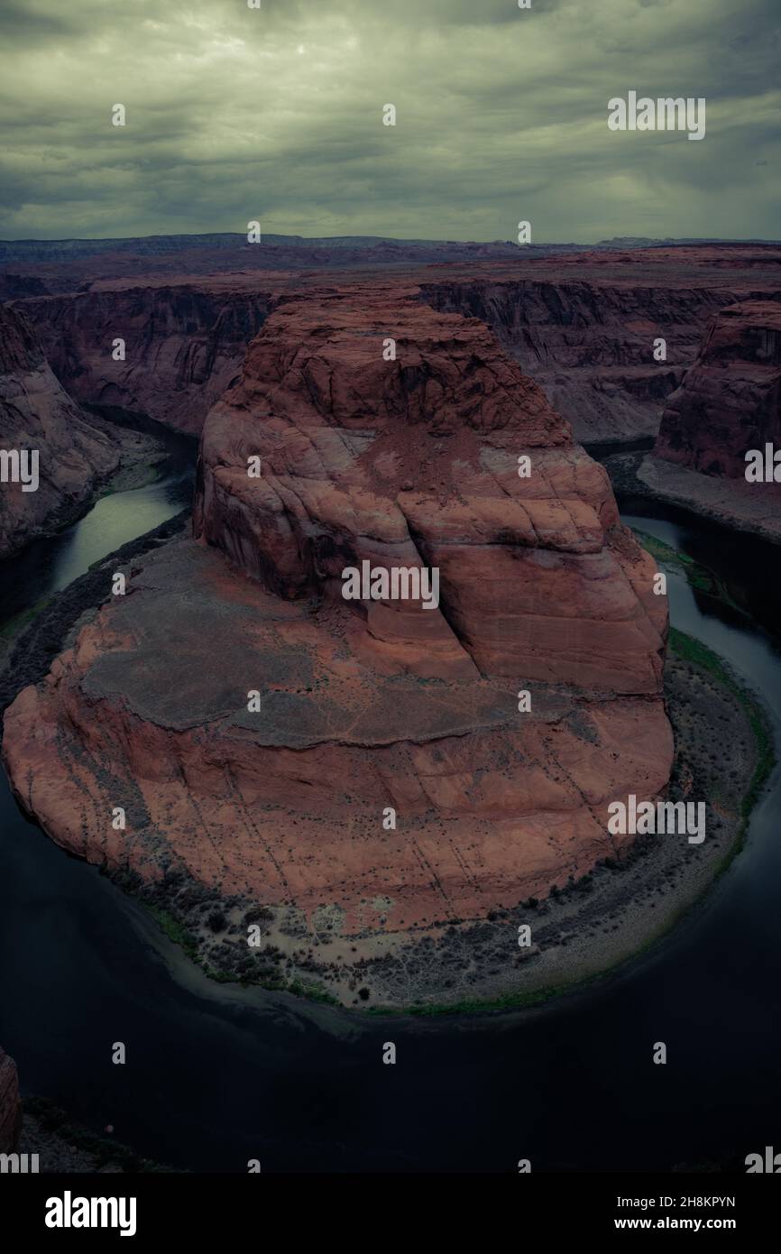 Vista de Horseshoe Bend, meandro en forma de herradura del río Colorado, nubes de tormenta en el cielo, Page, Arizona, Estados Unidos Foto de stock