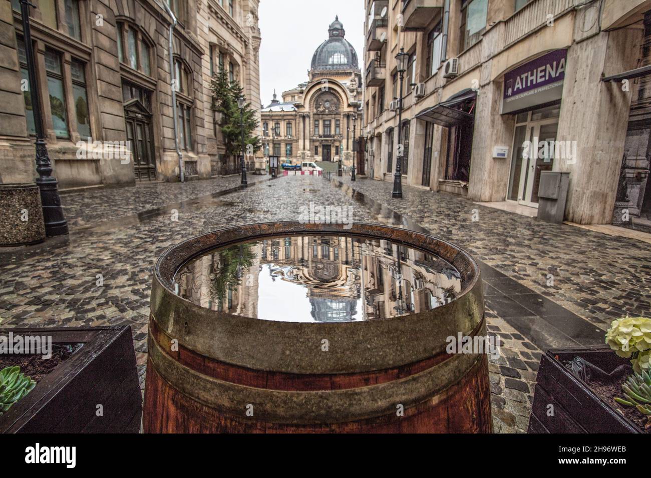 El Palacio de los depósitos y las remesas (palacio de los bancos) reflejo en barril en un día lluvioso, situado en el casco antiguo de Bucarest (Centru Vechi) Rumania. Foto de stock