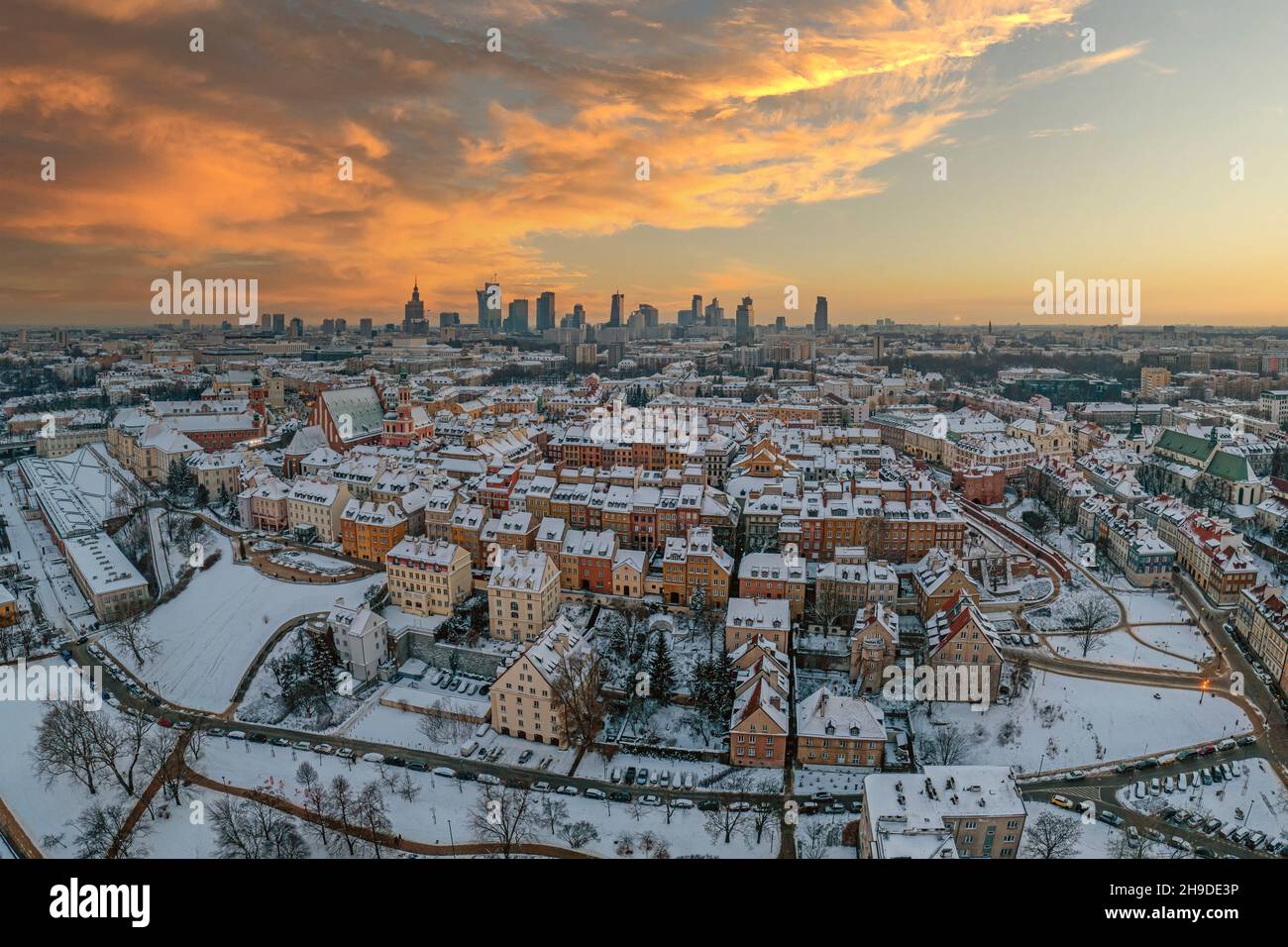 Ciudad vieja de Varsovia, techos cubiertos de nieve y el centro de la ciudad distante al atardecer, panorama aéreo de invierno Foto de stock