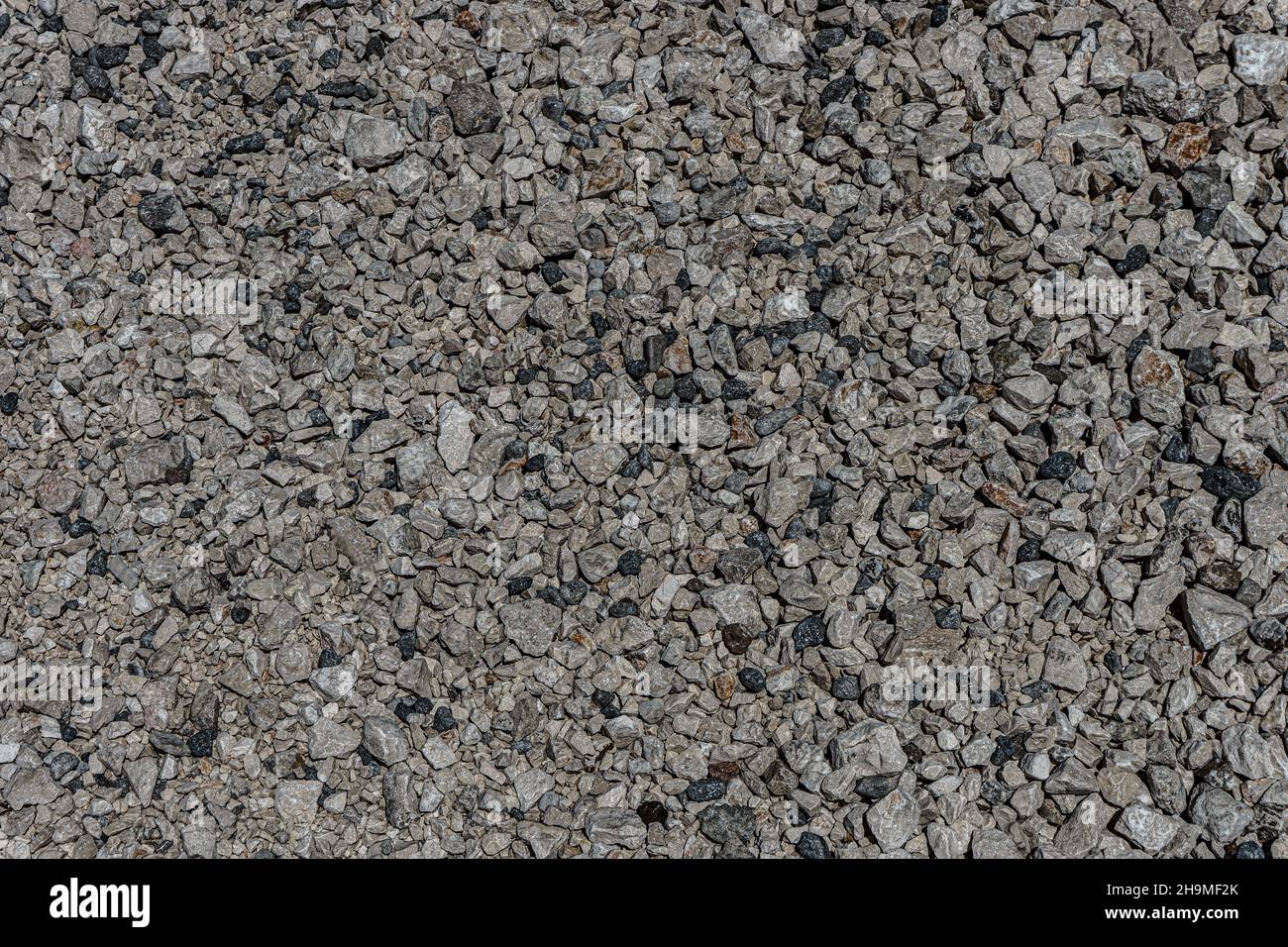 La textura de la grava fina. Fondo gris granito. Un montón de piedras