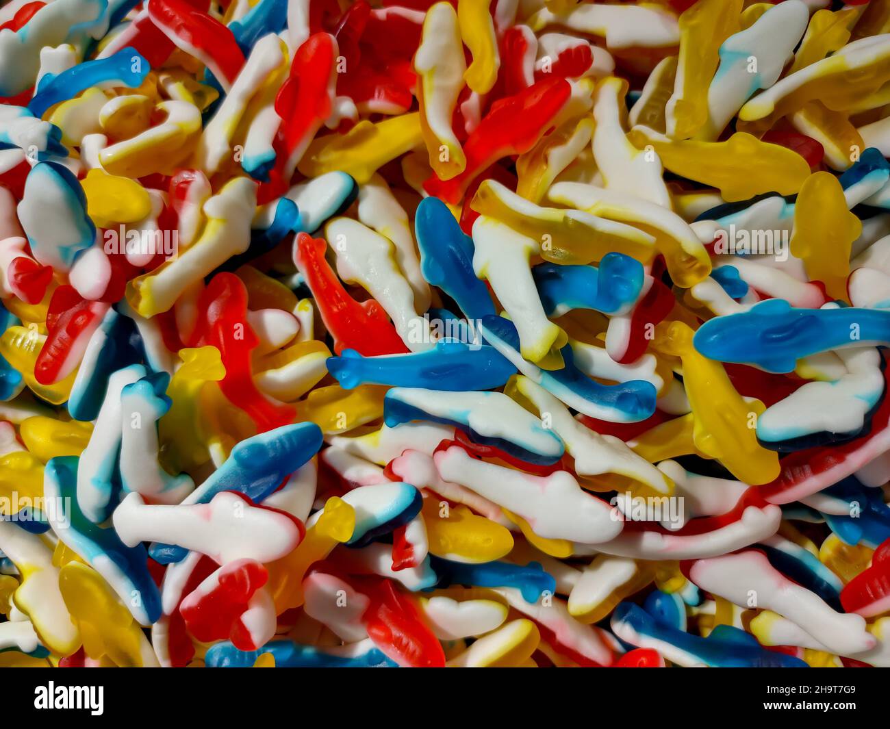 Antecedentes de caramelos de masticación multicolores de diferentes formas Foto de stock