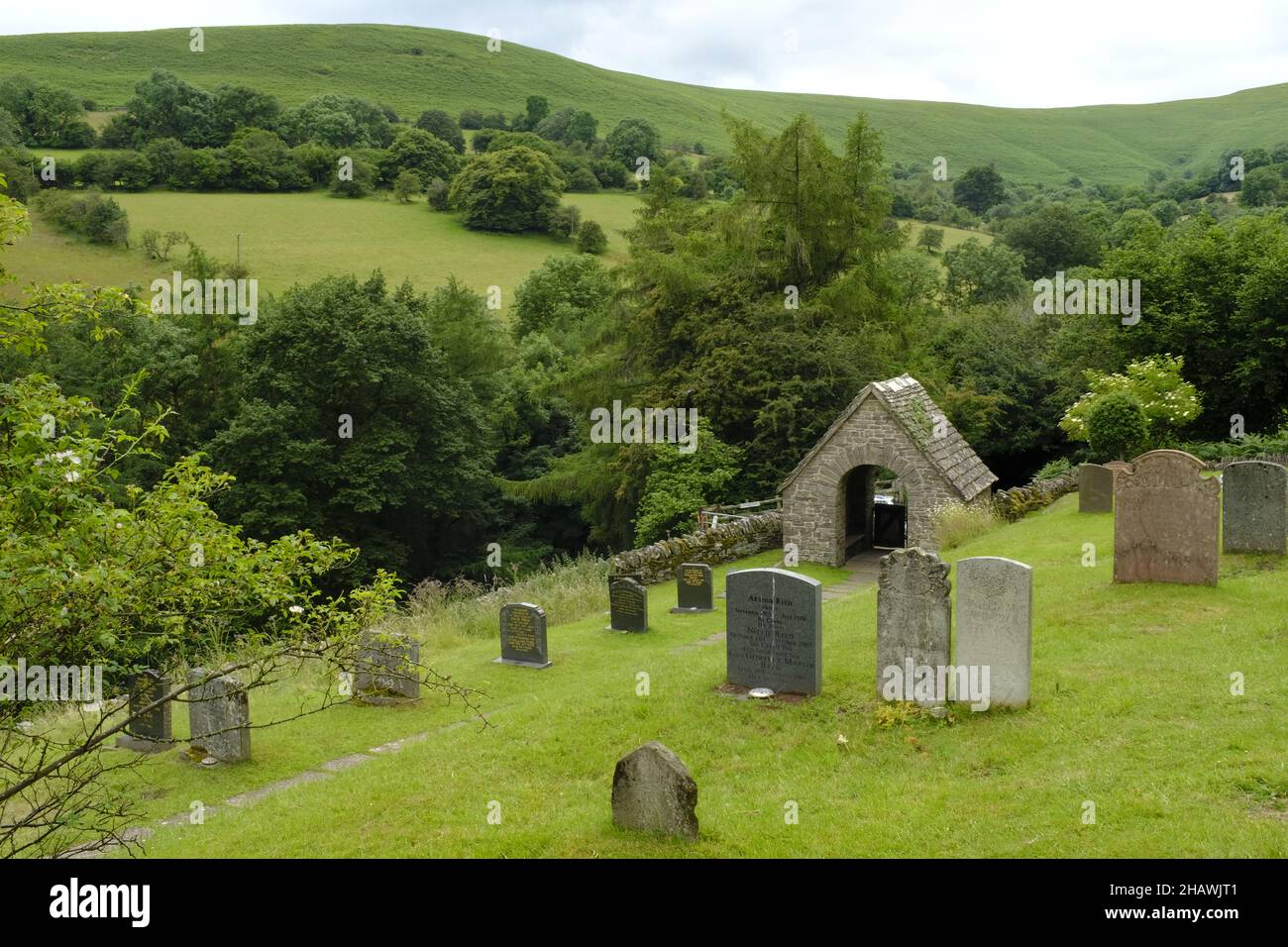 Cementerio de la Iglesia de San Issui y puerta cubierta en un paisaje montañoso, Partrishow, Powys, Gales, Reino Unido Foto de stock