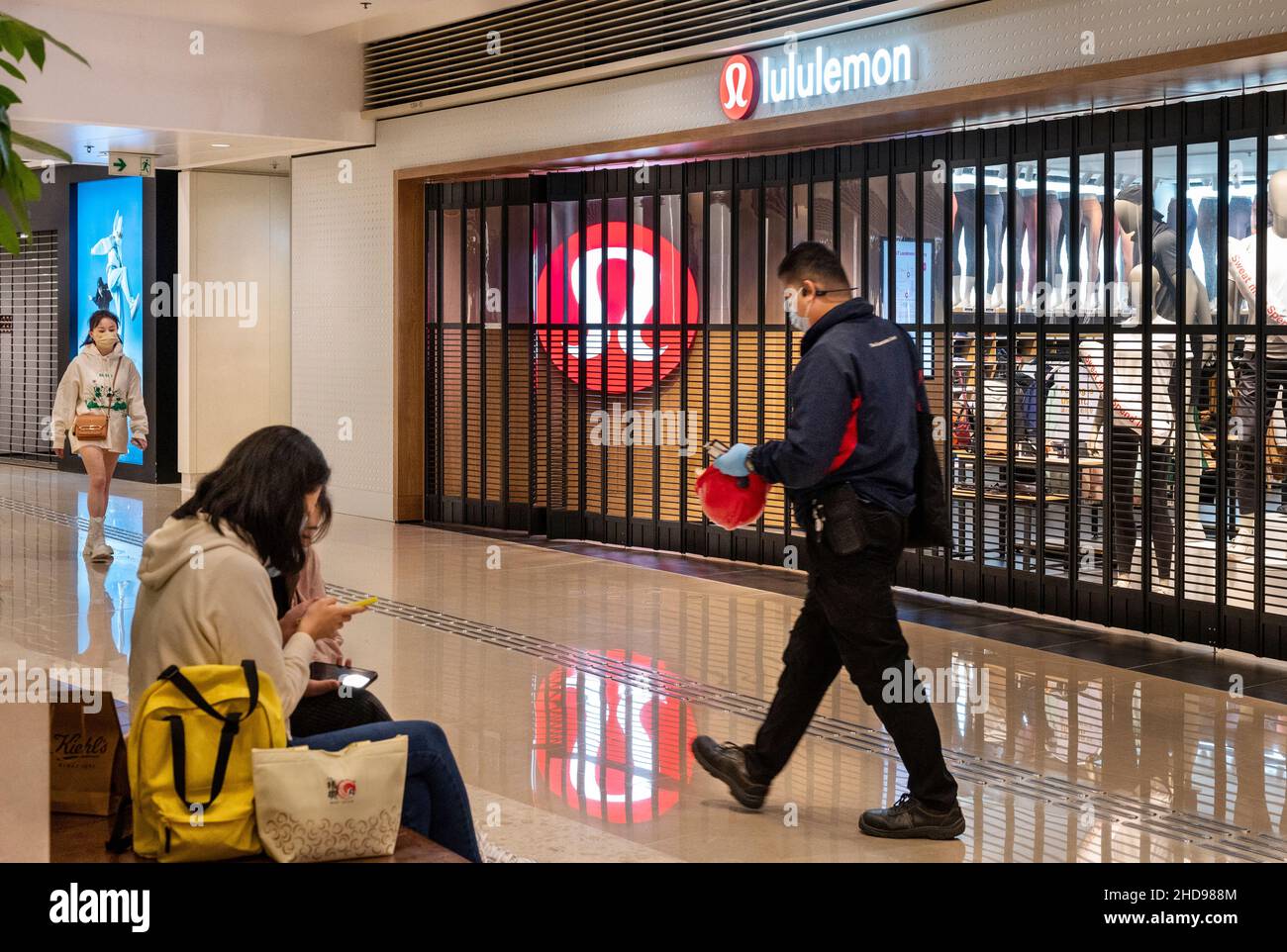 Los compradores pasan por una banda de ropa ropa deportiva canadiense cerrada, el logotipo de Lululemon y la tienda se ve en Hong Kong de stock - Alamy