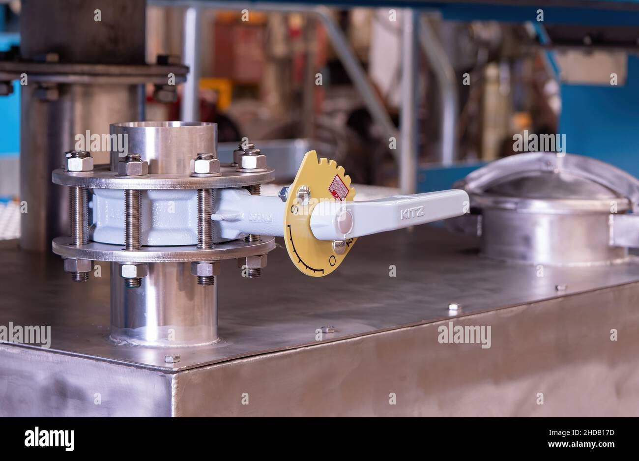 Válvula de mariposa accionada por palanca de Kitz instalada en un depósito de retención de acero inoxidable. Foto de stock