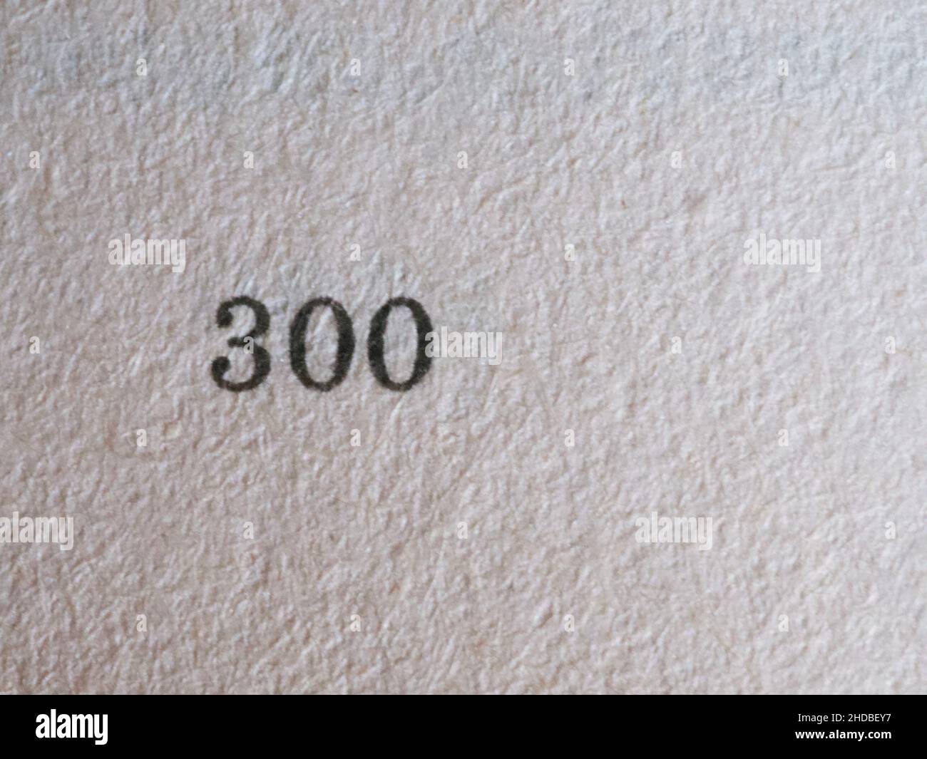 El número 300 impreso en un papel. Textura del papel Fotografía de