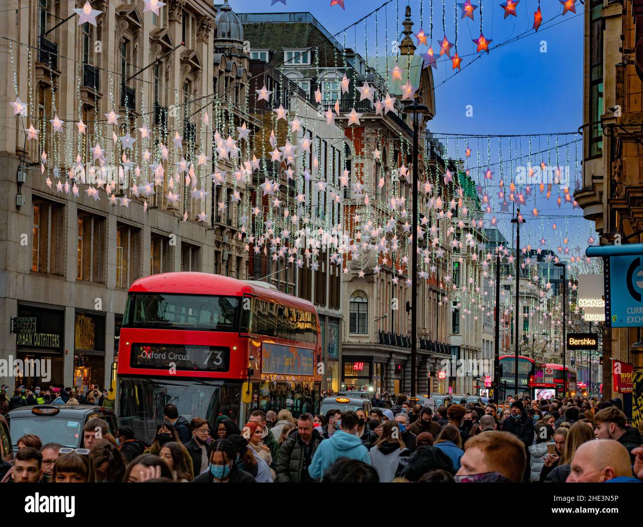 Londres, Inglaterra, Reino Unido - 18 de diciembre de 2021: Oxford street atestada por personas que disfrutan de las decoraciones de luces navideñas en el centro de Londres Foto de stock