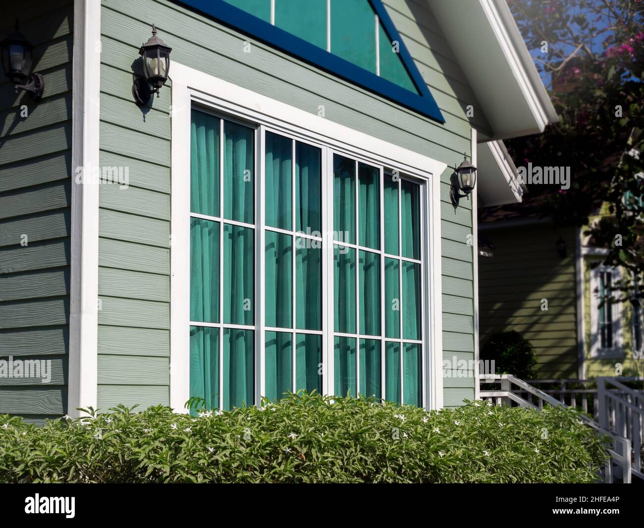 Ventana decorativa con persianas de madera verde en la pared de la casa  Fotografía de stock - Alamy