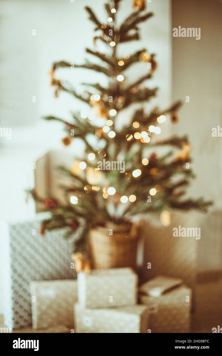 Envolvió regalos de Navidad bajo un árbol de Navidad en una sala de estar Foto de stock