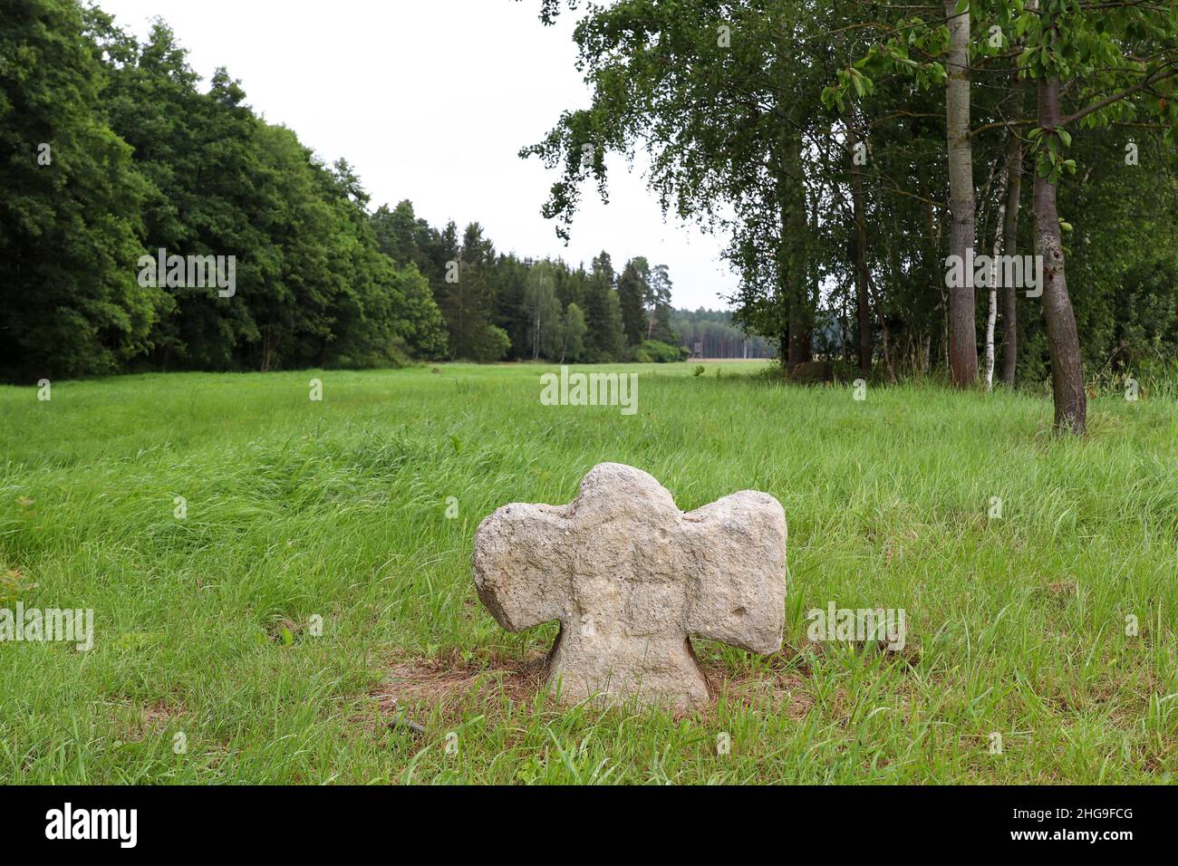 Antigua cruz de piedra con un relieve de la cruz - cruz de conciliación cerca de la aldea de Hubenov, región de Pilsen Foto de stock