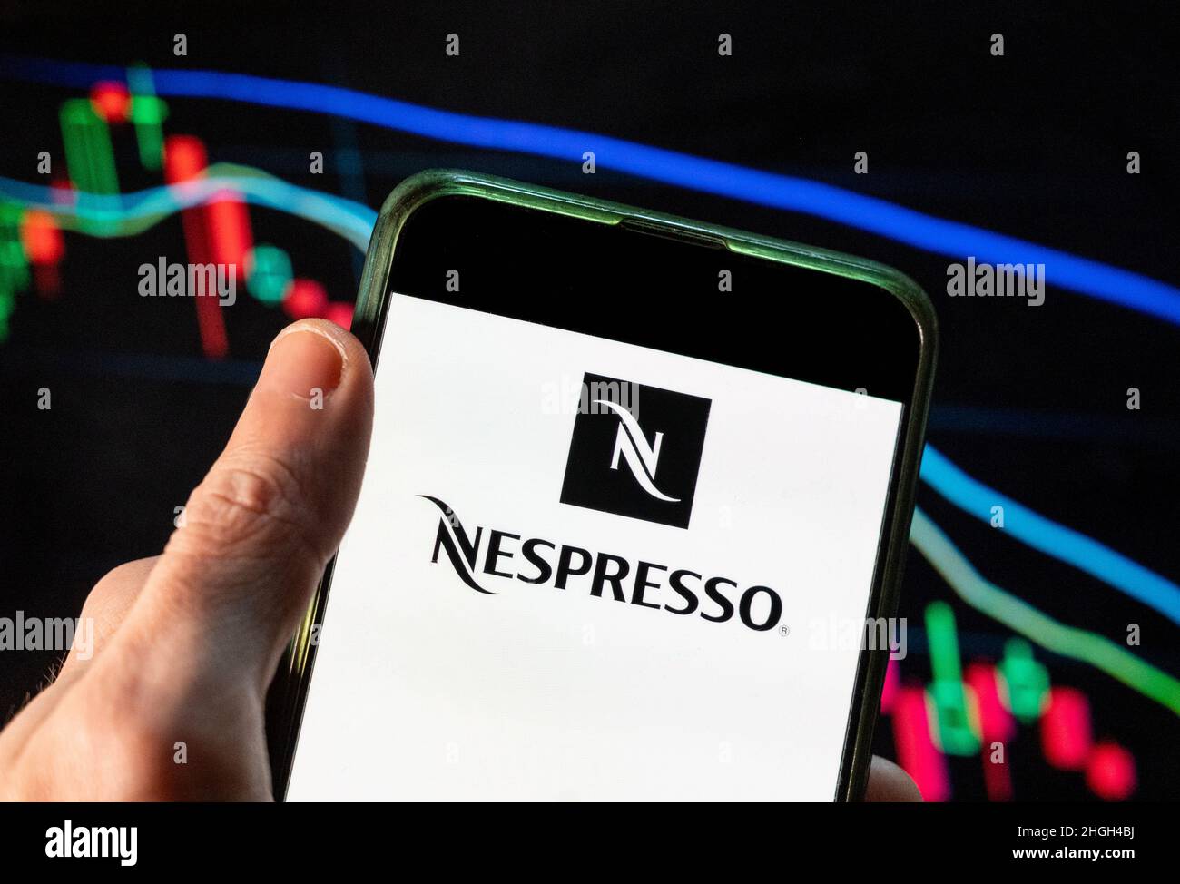 En esta ilustración de la foto, el logotipo Nespresso de la tienda de alta  gama suiza y líder mundial en cápsulas de café se muestra en un smartphone  con un gráfico de