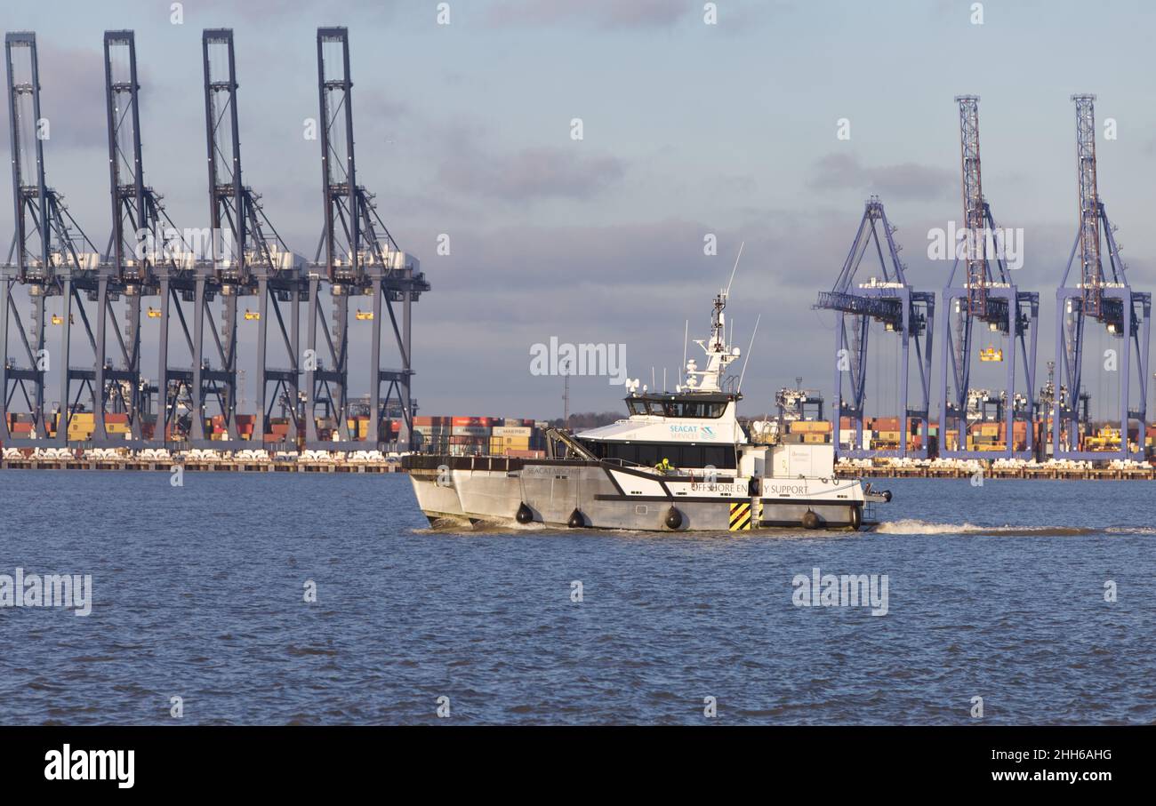 El buque de apoyo energético de alta mar Seacat Mischief entra en Harwich Haven con el Port Felixstowe en el fondo. Foto de stock