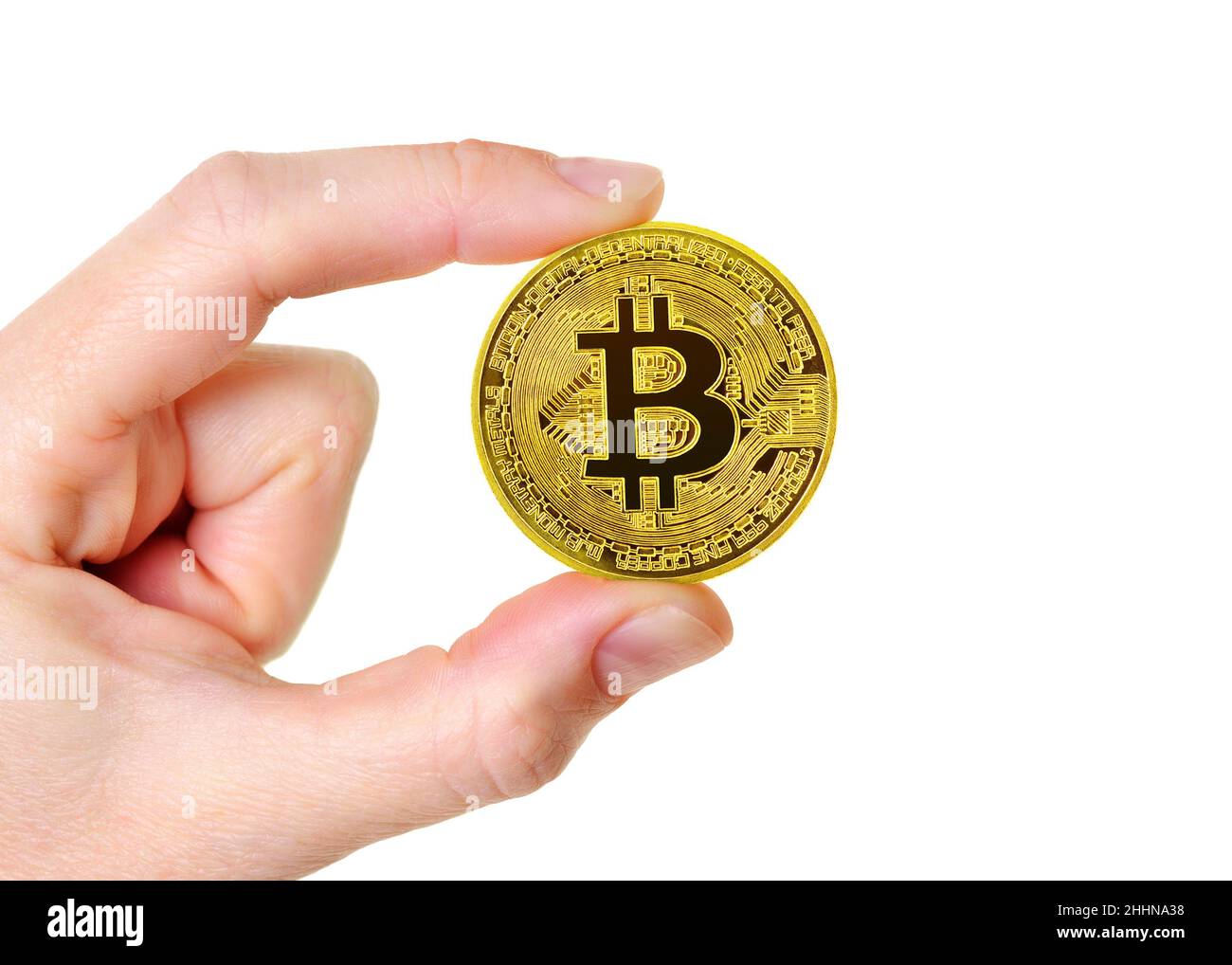 Moneda de criptomoneda Bitcoin sostenida contra un fondo blanco Foto de stock