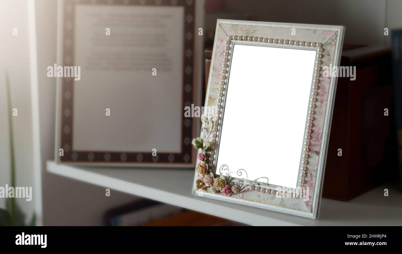 Embolse un marco de fotos en un estante con espacio en blanco Foto de stock