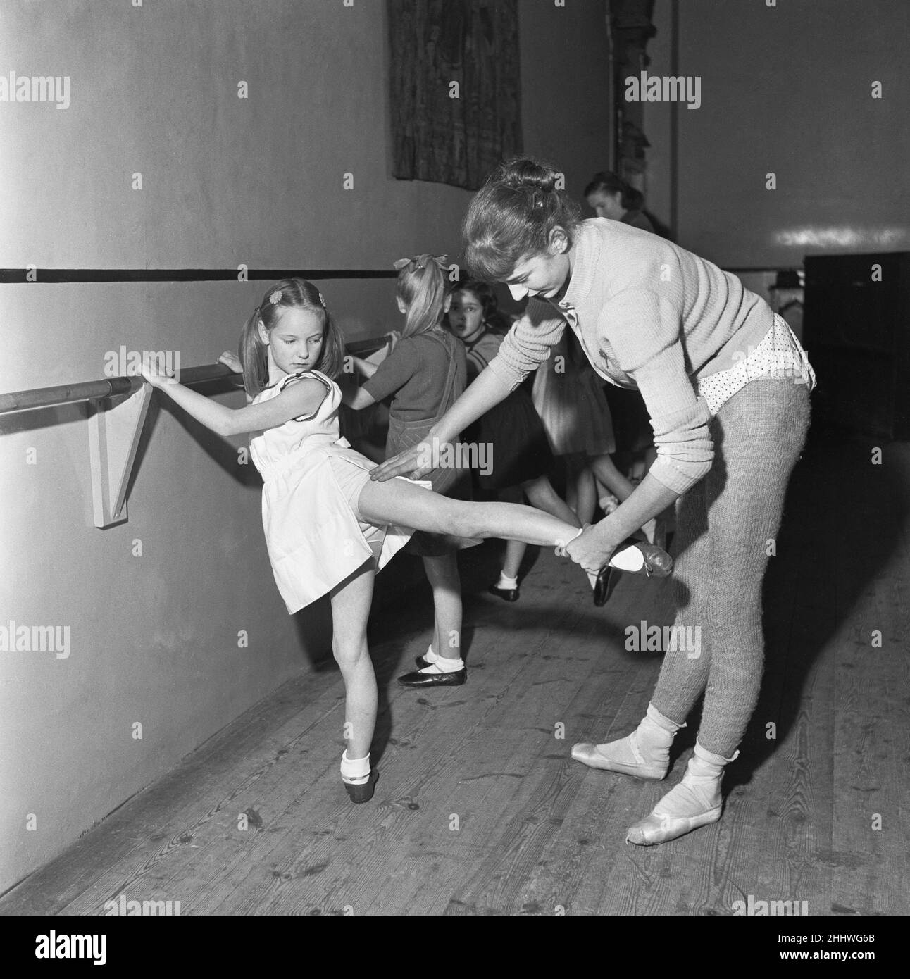 Clases de bebés y niños pequeños que tienen sus clases de ballet en la Escuela Rambert en el Teatro Mercury, Notting Hill Gate. Los maestros para las clases de bebés son alumnos de la tercera edad, mientras que las clases de menor edad más avanzadas son tomadas por un maestro de ballet experimentado, el 15th de enero de 1954 Foto de stock