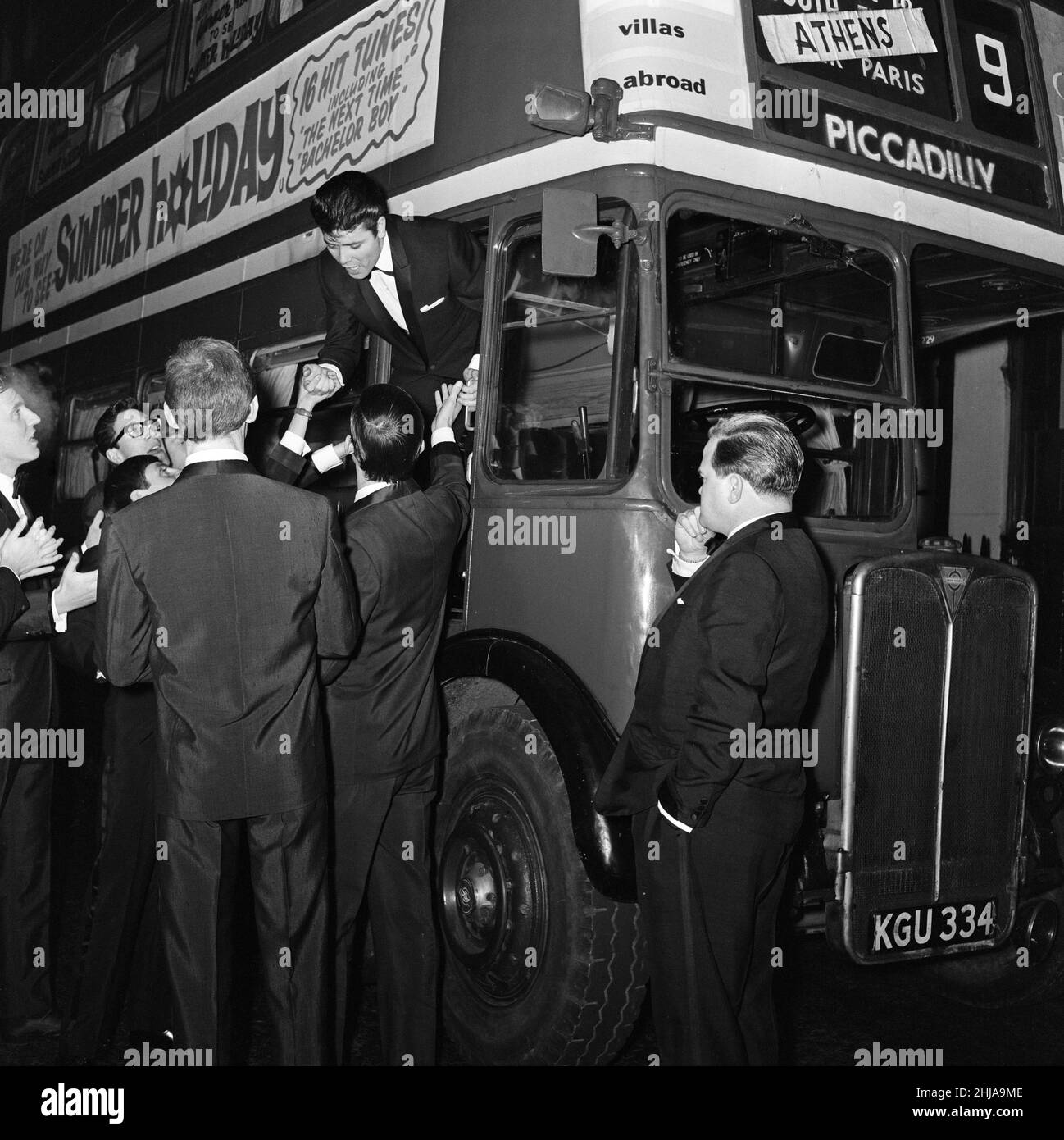 Cliff Richard y algunas de las sombras con un autobús de transporte de Londres. El elenco de la película había planeado llegar al estreno de la película, 'Vacaciones de verano' en el autobús. A Cliff Richard se le impidió asistir al premier debido a los aficionados que se agolpaban alrededor de su coche cuando entró en Leicester Square. 10th de enero de 1963. Foto de stock