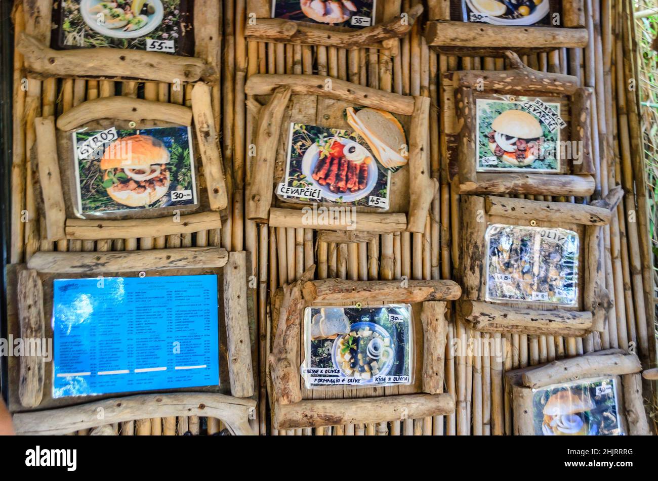 Menú de comida y bebida Demontrado en fotos enmarañadas colgadas en la pared de un club de verano en Pula, Istria, Croacia. Decoración hecha a mano con caña de bambú Foto de stock