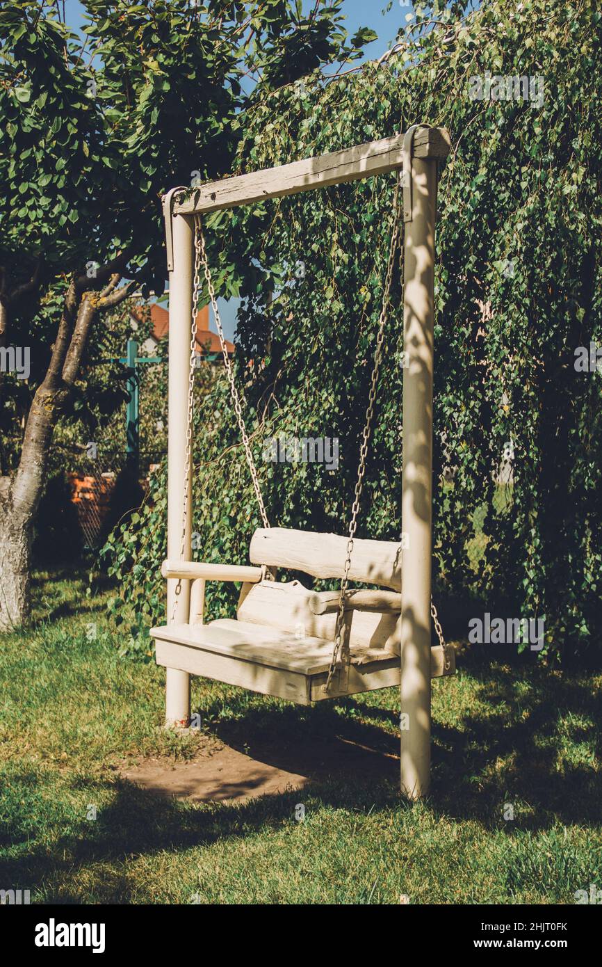 Columpio de madera blanca en el jardín. Un lugar romántico Fotografía de  stock - Alamy