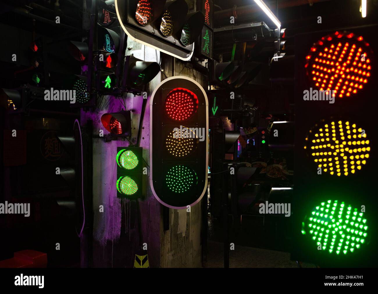 Las luces verdes rojas amarillas se iluminan simultáneamente en la pantalla de varios semáforos Foto de stock