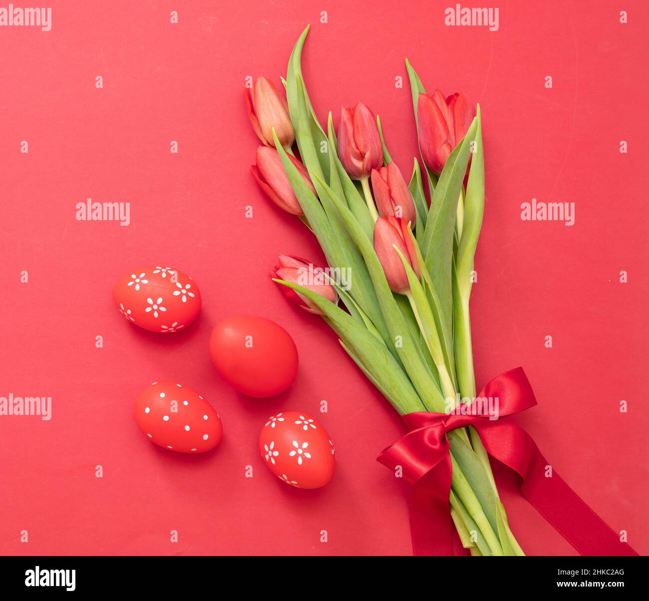 Decoración de Pascua. Vista de la parte superior del ramo de tulipanes y huevos con pintura roja. Religión cristiana celebración de las vacaciones de primavera. Foto de stock