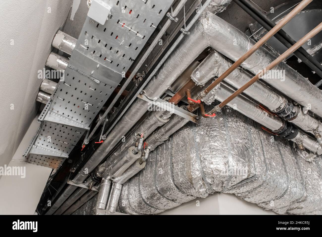 Sistema de aire acondicionado de ventilación en material de aislamiento  térmico Conducto de tubería hvac en el techo de una planta industrial  Fotografía de stock - Alamy