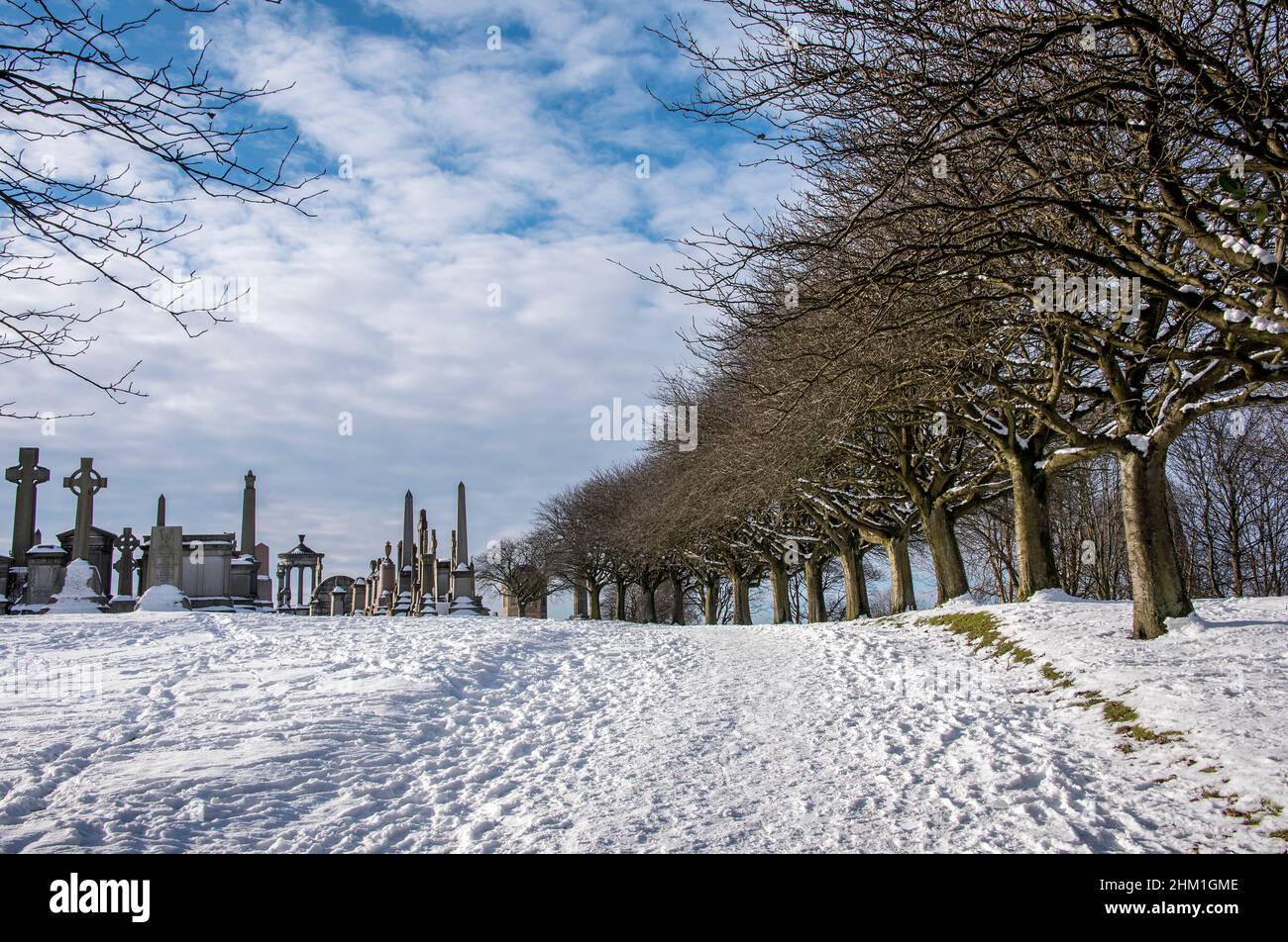 Camino cubierto de nieve en Necrópolis Victorian Cemetery Glasgow Escocia. Foto de stock